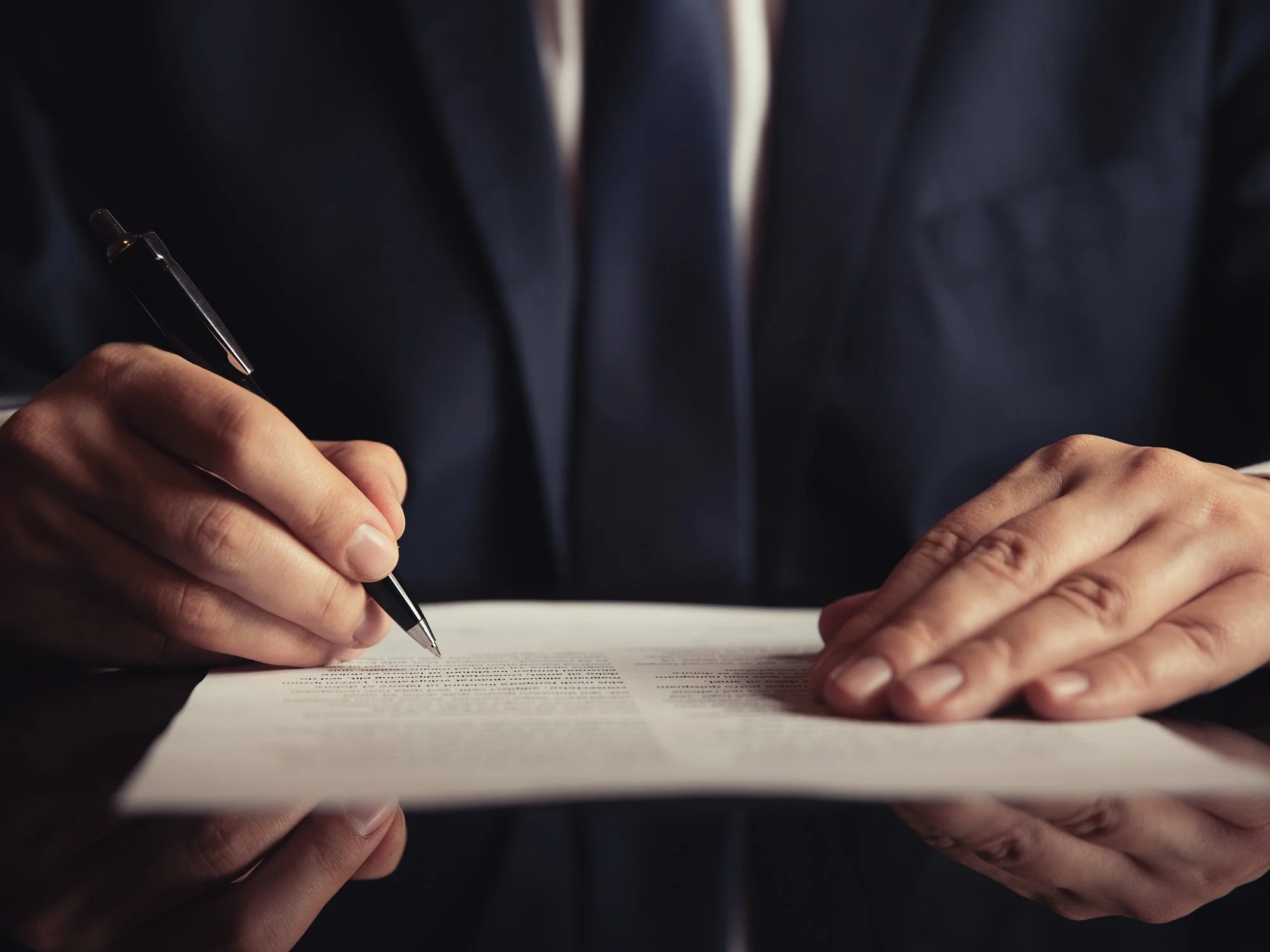 Man's hands with a pen - Fiduciary Standard Advisor