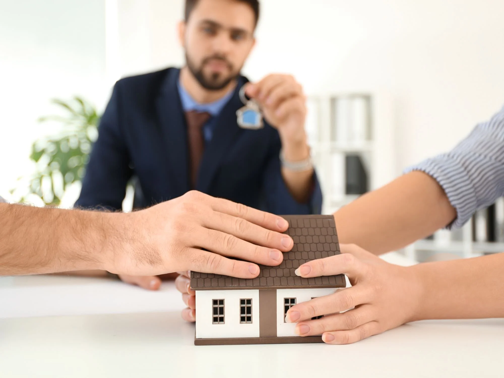 two people with hands on house pulling it - QRDO divorce