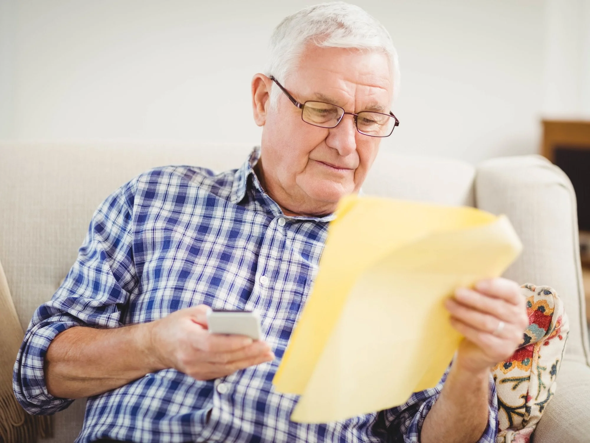 older man looking over documents