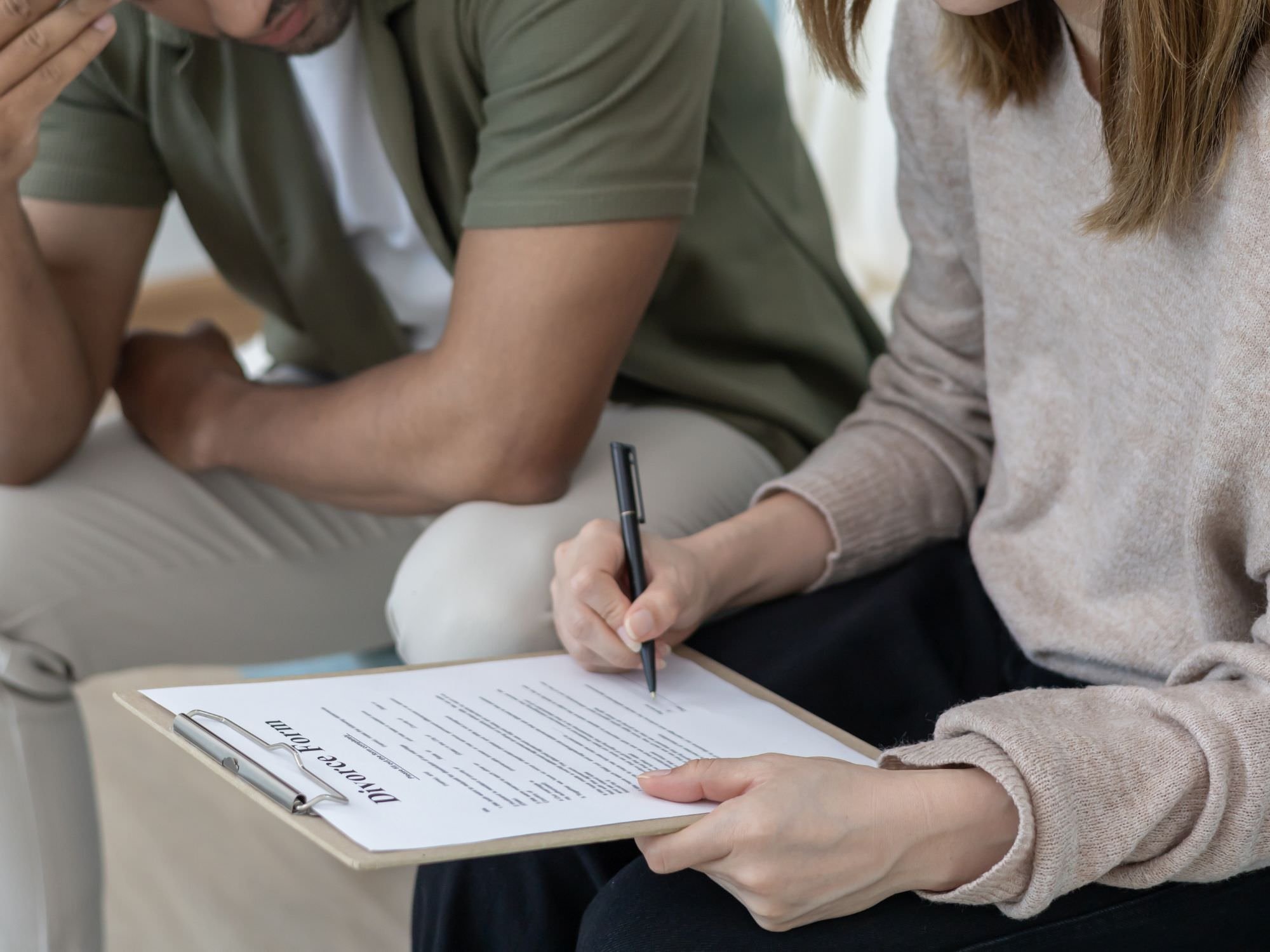 Couple signing divorce papers - ira divorce