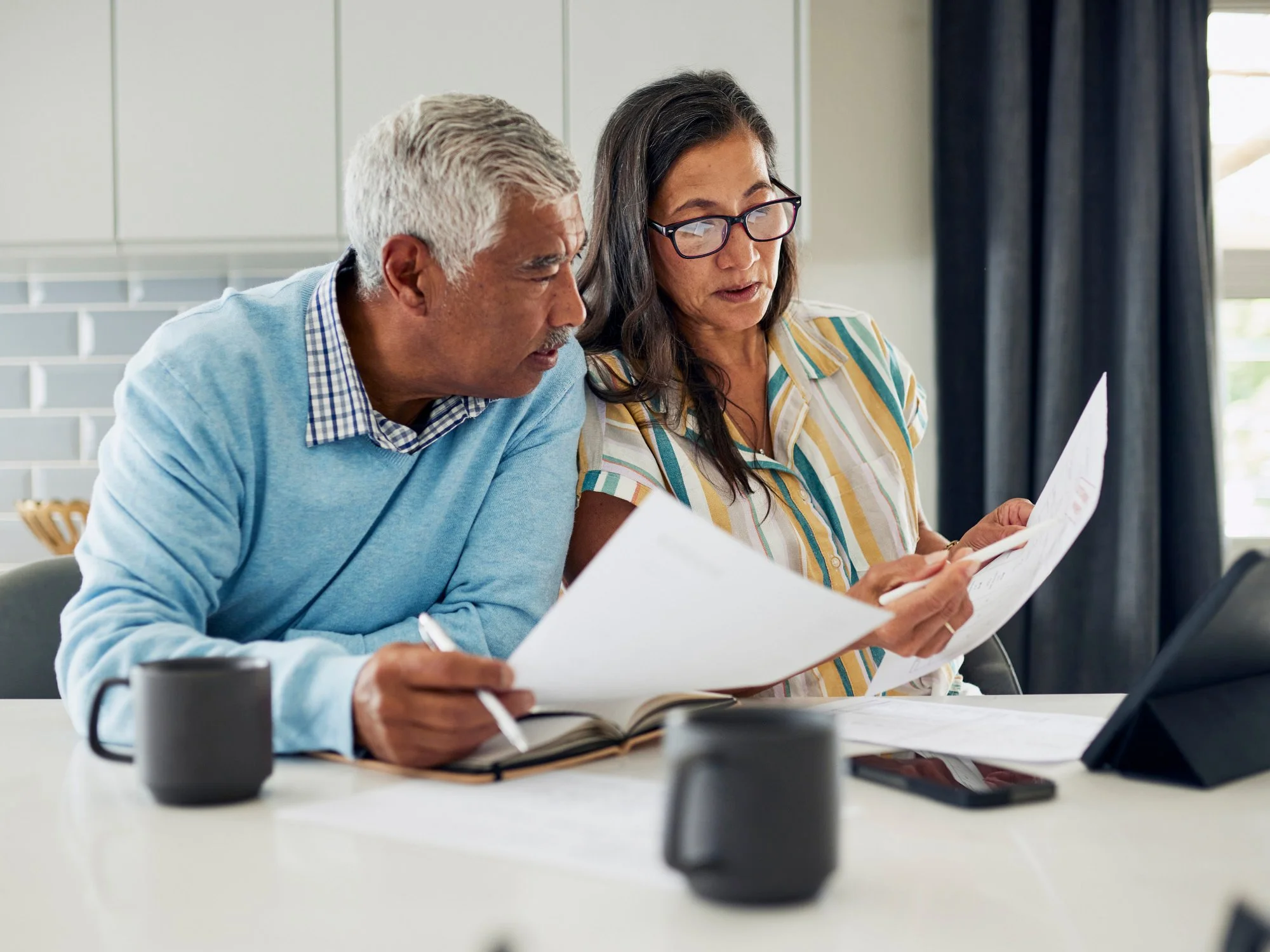 Older couple reviewing financial papers - Fiduciary Standard Advisor