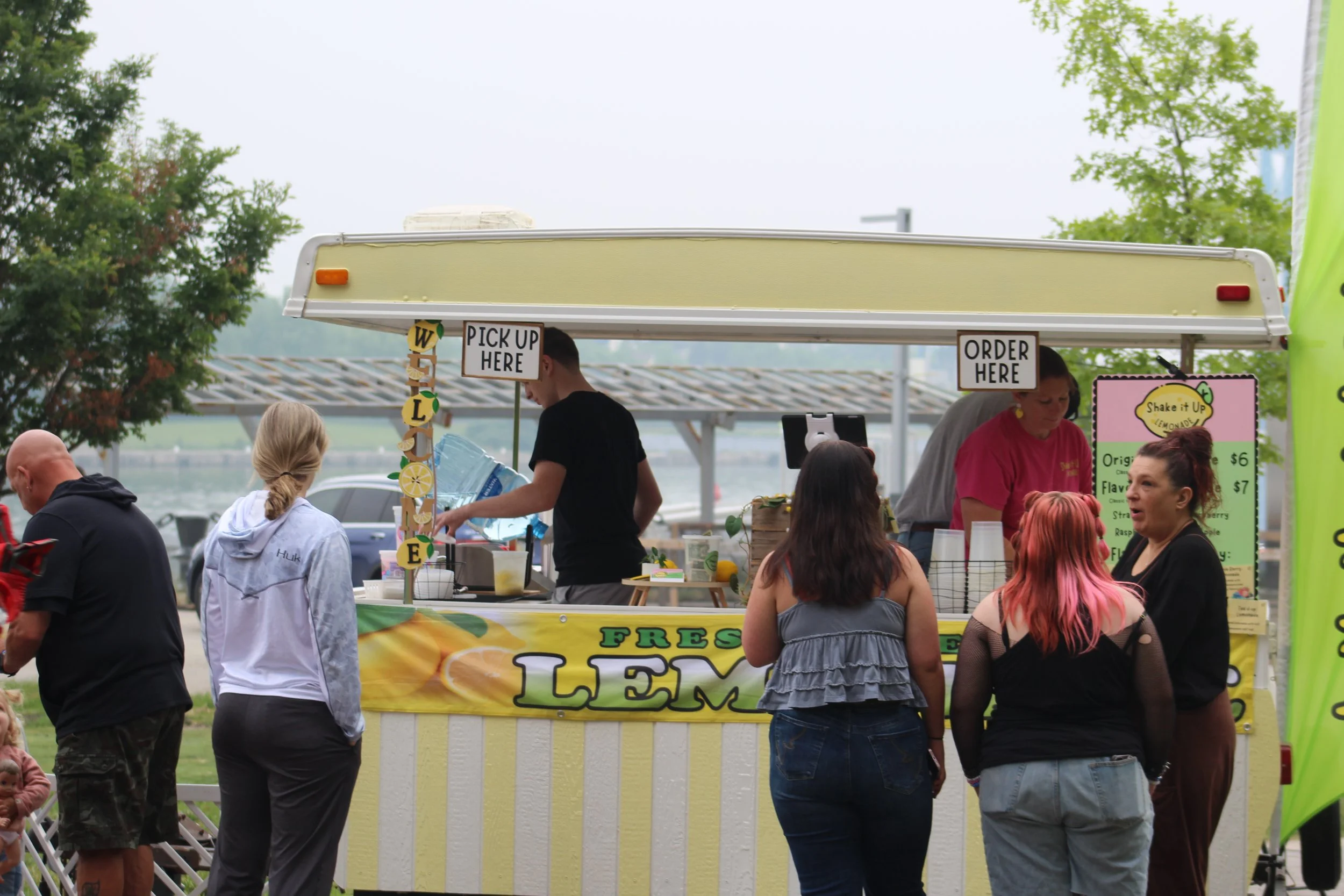 Customers waiting at Shake It Up Lemonade stand at Strawberry Fest in Coldwater Michigan