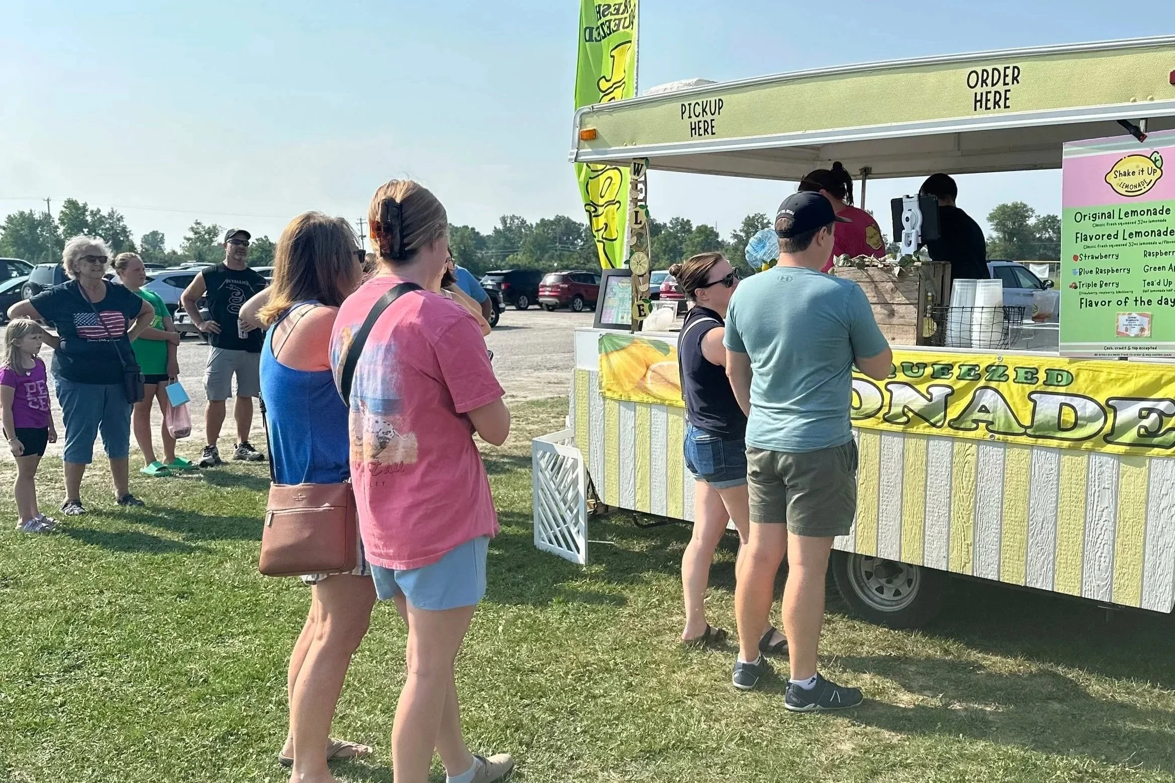 Customers waiting at Shake It Up Lemonade stand at Whiteford Farmers Market in Ottawa Lake, Michigan.
