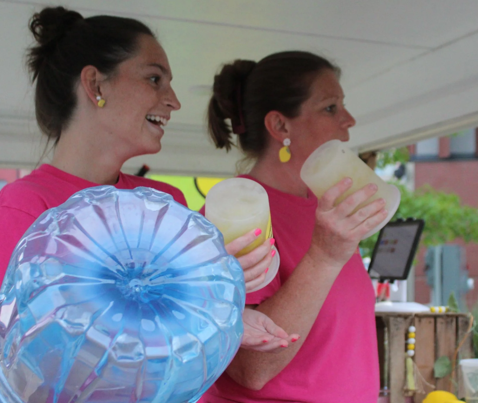 Shake It Up Lemonade team members holding drinks at Party in the Park at Downtown Toledo event