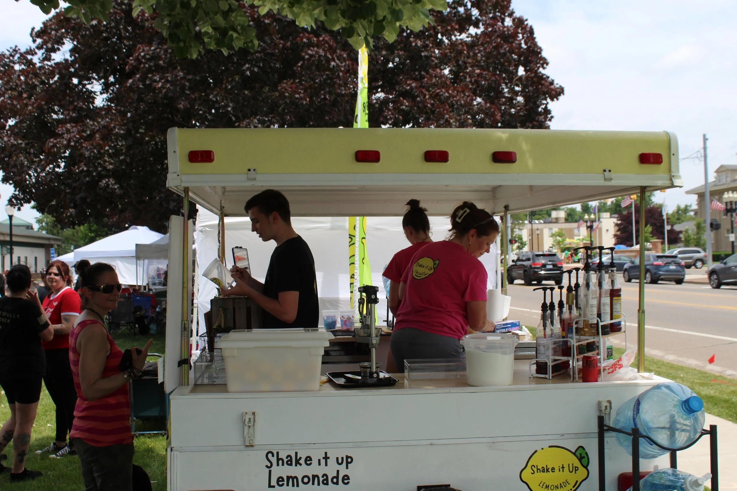 Customers waiting at Shake It Up Lemonade stand at Strawberry Fest in Coldwater Michigan