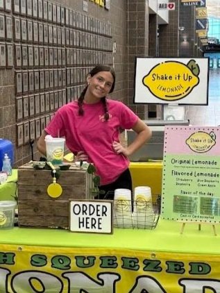 Shake It Up Lemonade team member Abby serving lemonade at Darkhorse Wrestling Tournament in Saline Michigan.