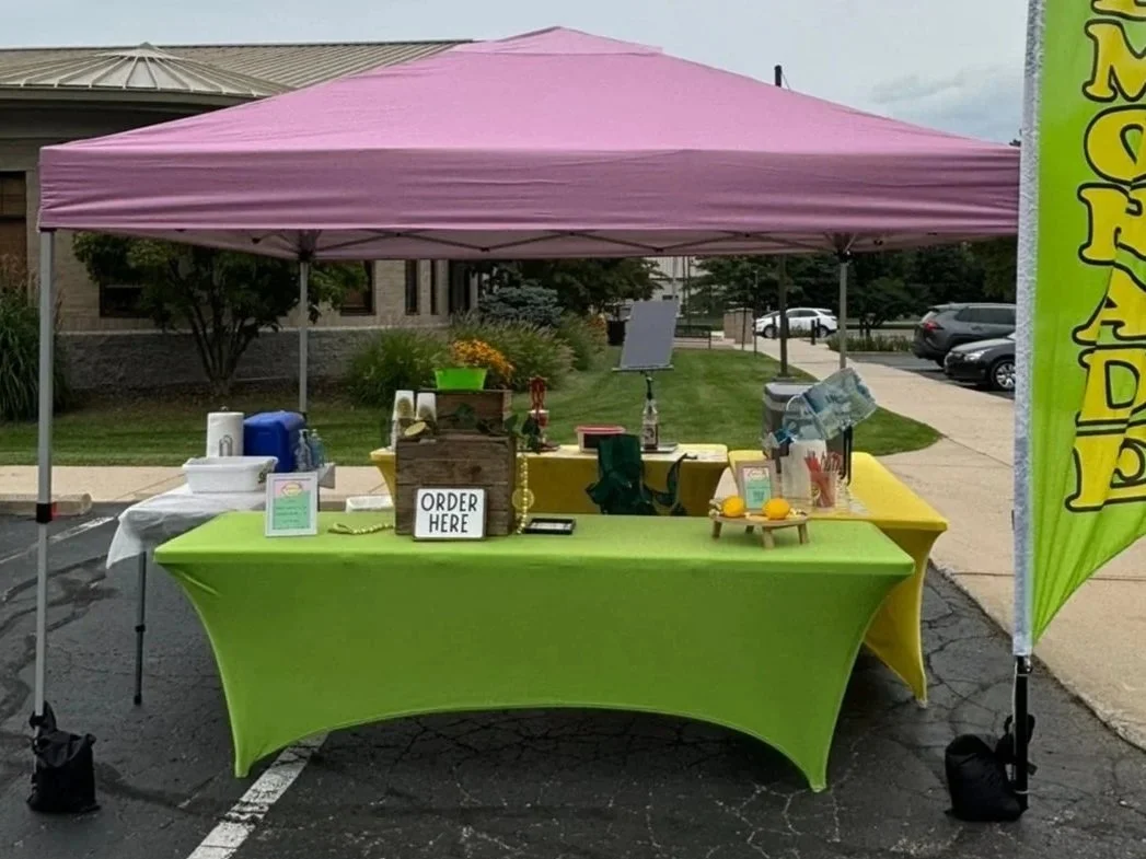 Shake It Up Lemonade tent set up serving fresh squeezed lemonade at Bedford Public Library in Temperance, Michigan