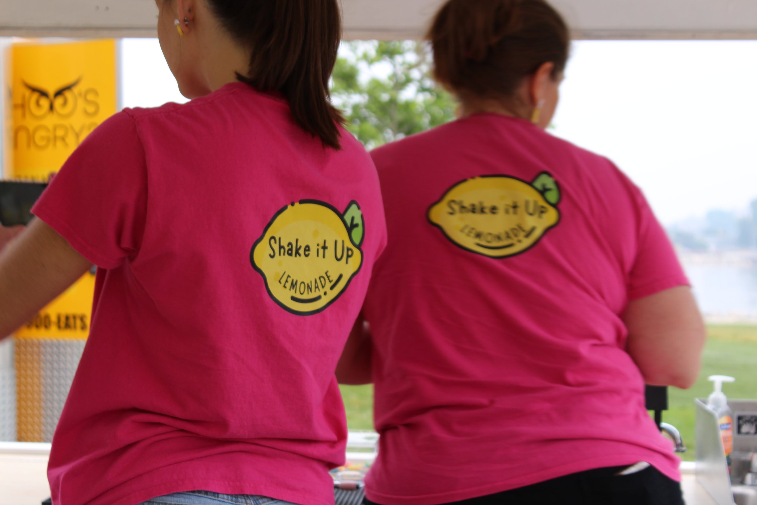 Shake It Up Lemonade team members at an outdoor lemonade mobile drink trailer in Coldwater, Michigan
