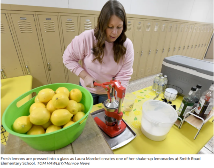 Fesh lemons being squeezed into cup for Shake It Up Lemonade