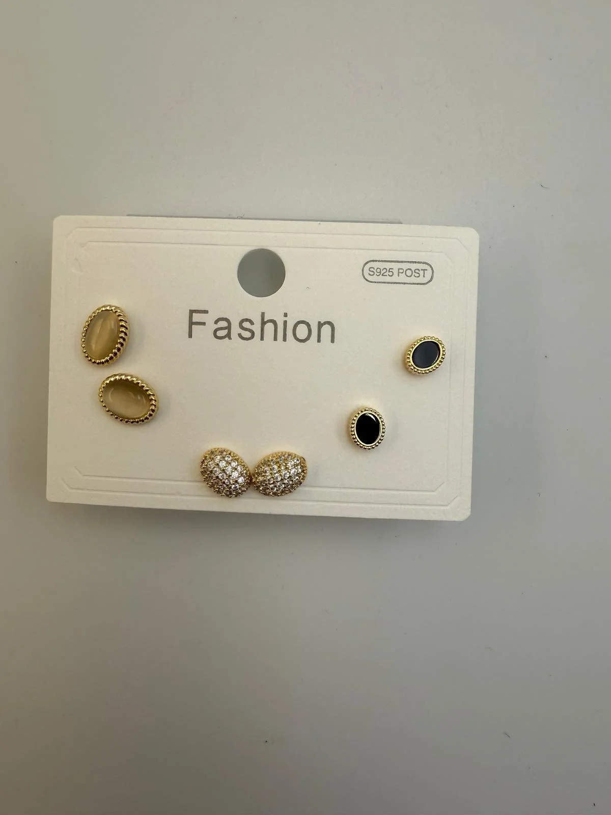 Set of five pairs of earrings on a white display card labeled "Fashion" with a hole at the top for hanging, and a S925 POST marking in the top right corner.