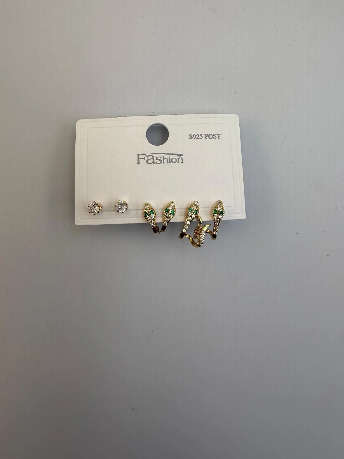 A white jewelry display card with two pairs of stud earrings and three pairs of dangling earrings, labeled 'Fashion' and 'S925 POST'.