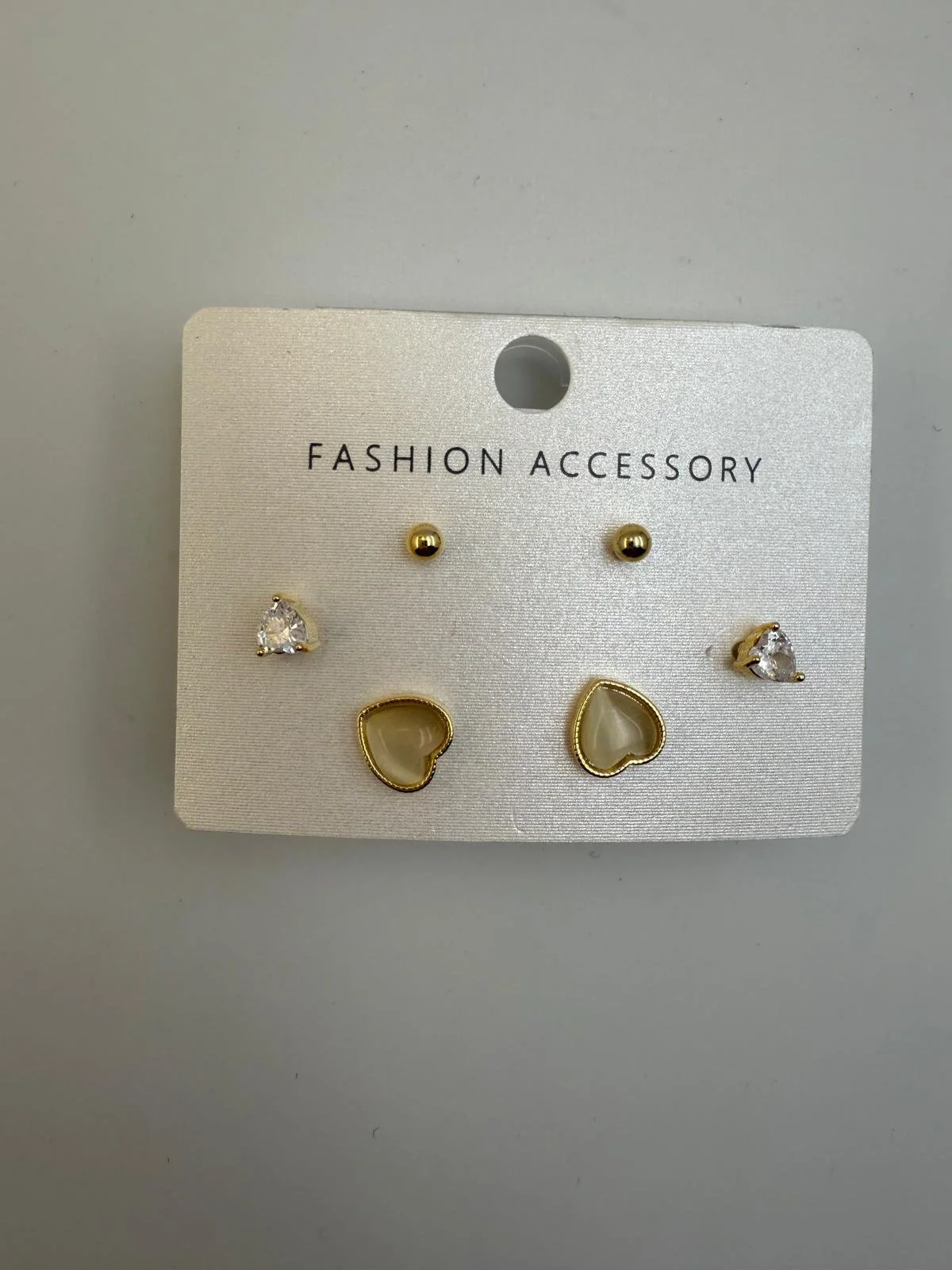 Set of five fashion earrings with hearts and stones, arranged on a white card labeled 'Fashion Accessory'.