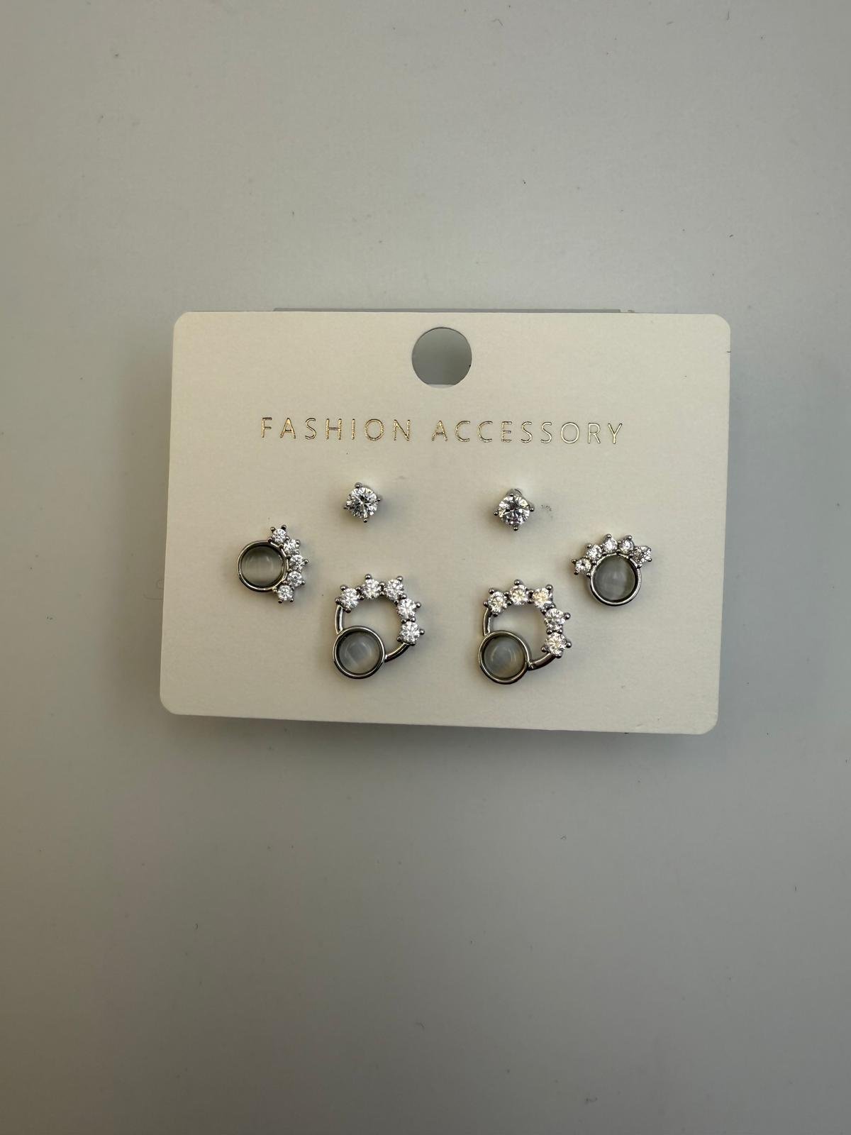 Set of six pairs of silver earrings with clear rhinestones, displayed on a white card labeled 'Fashion Accessory'.
