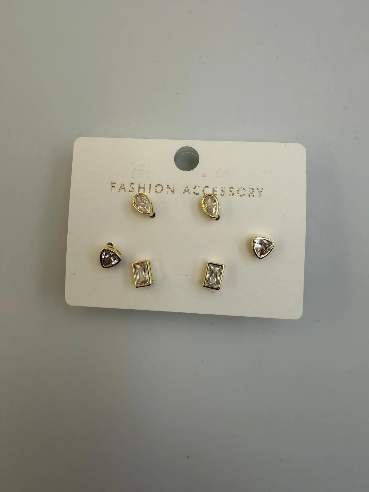 Set of six fashion earrings with different shapes and clear stones, displayed on a white card labeled 'Fashion Accessory'.