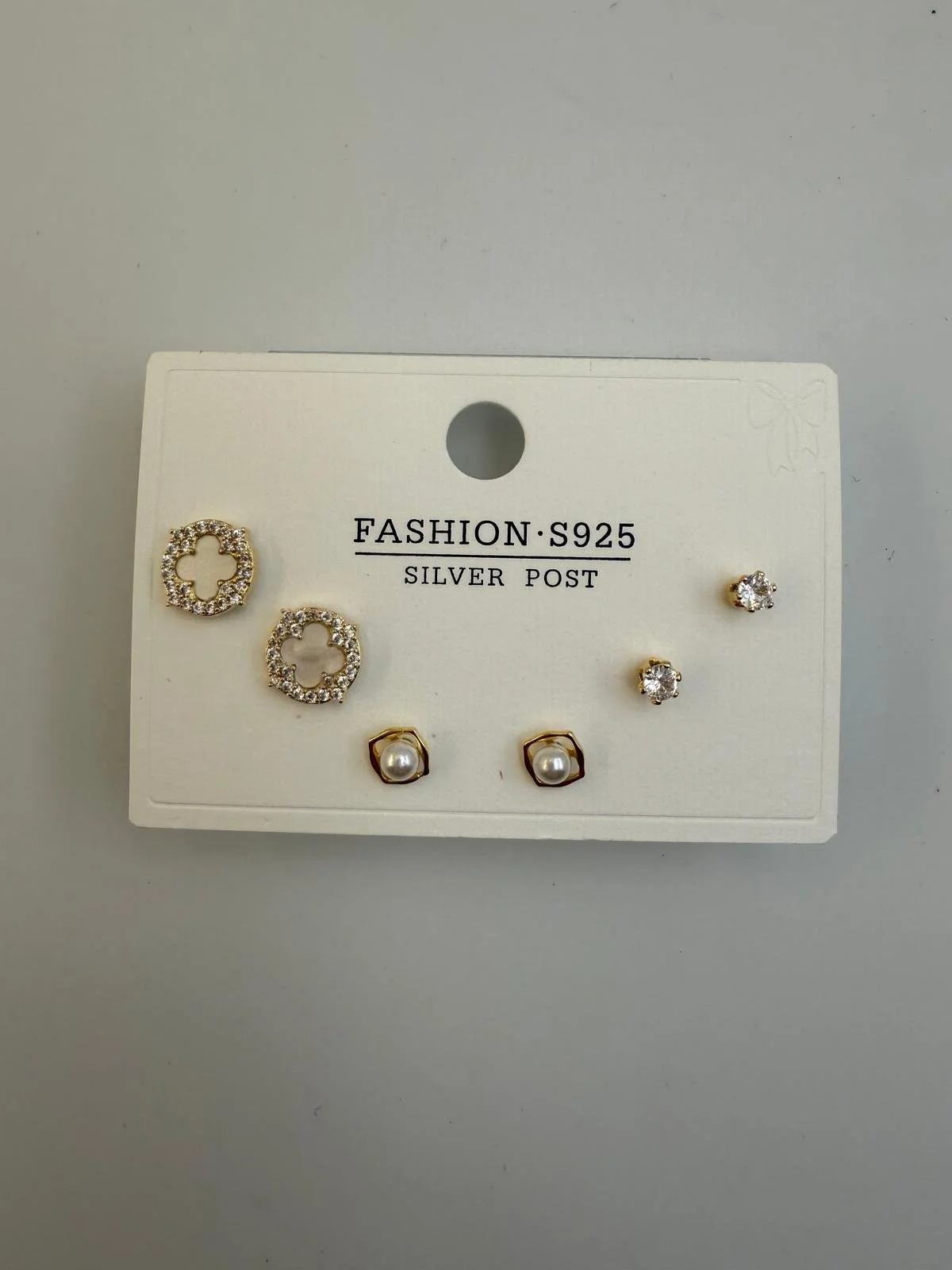 Set of six earrings on a white card. Two gold and pearl earrings at the bottom, two floral-shaped earrings with rhinestones at the top left, and two small round rhinestone earrings at the top right. The card has the text 'FASHION S925 SILVER POST'.