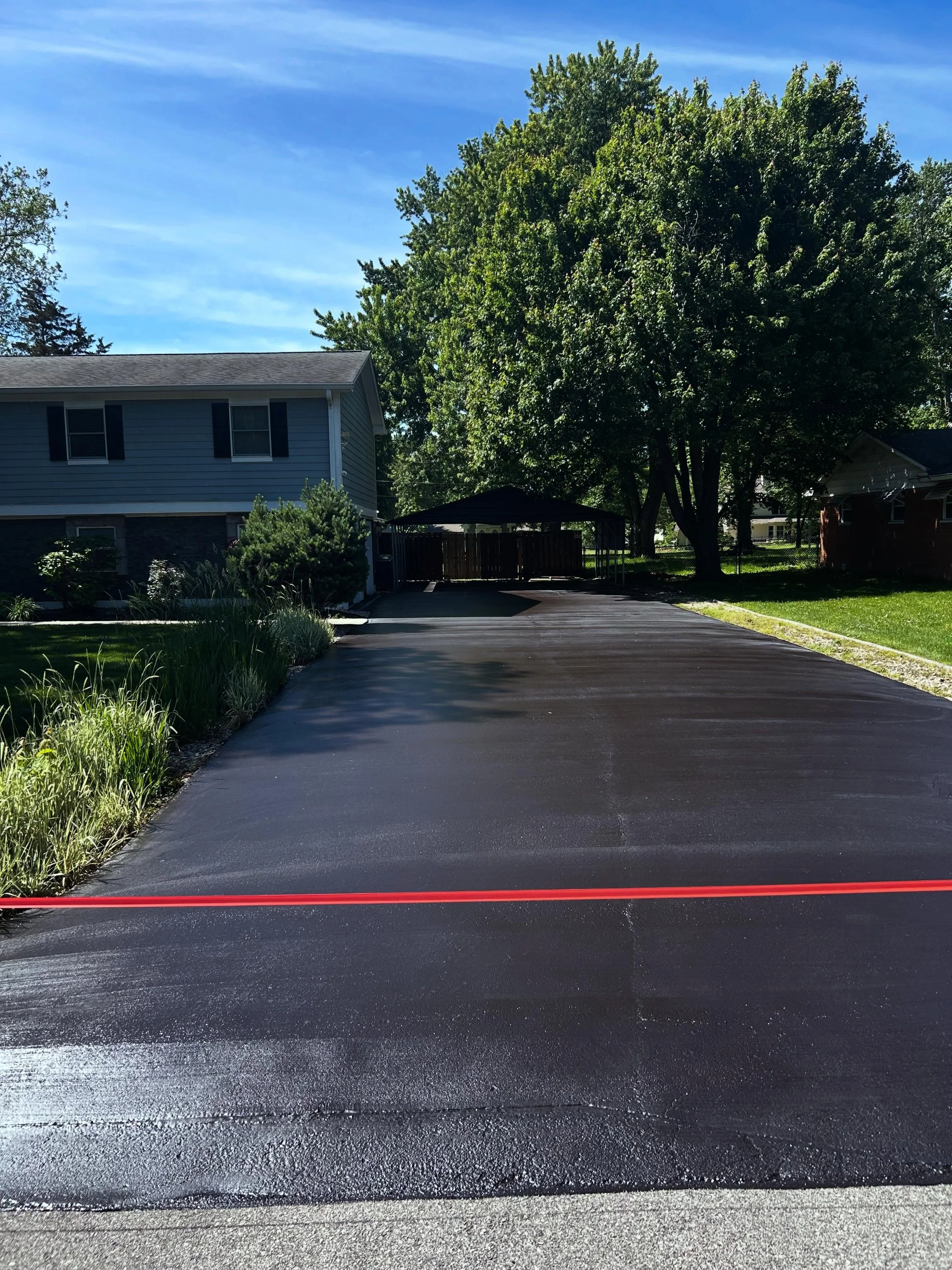 Greenwood, Indiana driveway received a fresh sealcoat after Memorial Day by Blacktop Boss. 