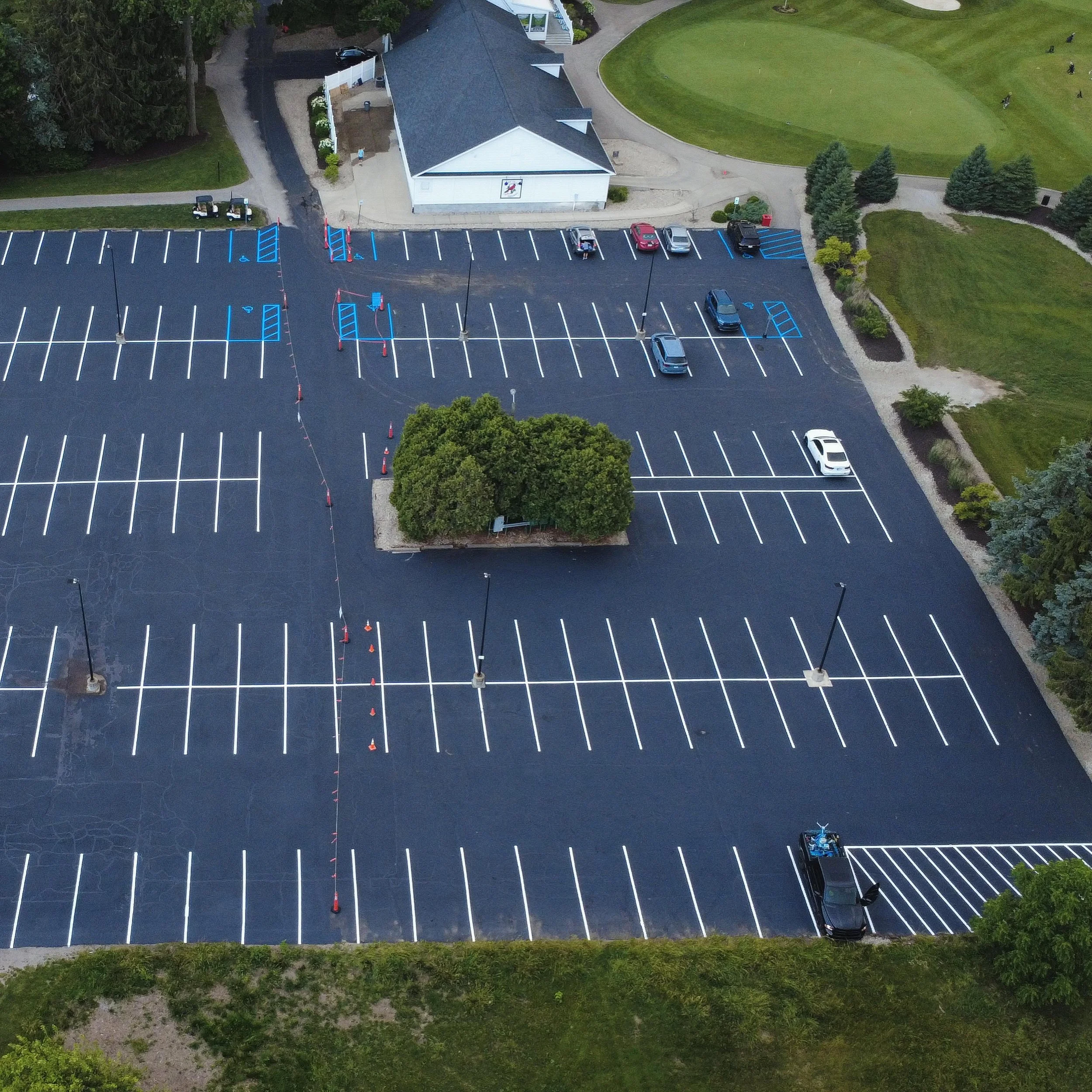 Golf course in Whitestown, Indiana with sealcoating, crackfilling, and parking lot striping completed by Blacktop Boss. 