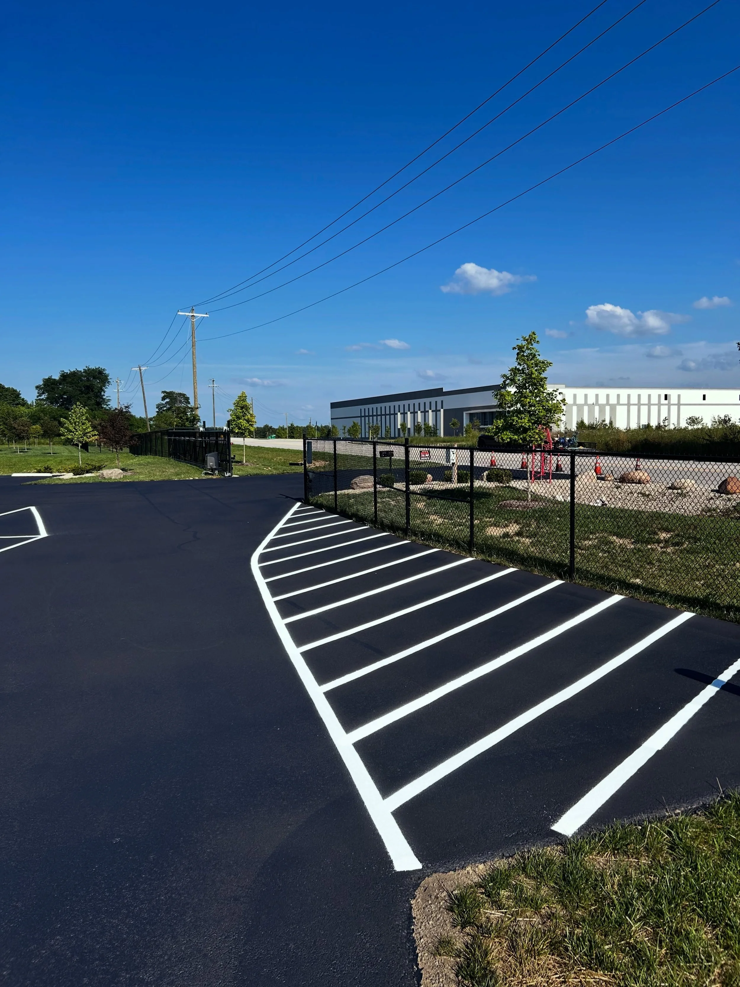 All Crane, a commercial parking lot in Fairland, Indiana got their parking lot sealcoat, crackfilled, and parking stalls restriped by Blacktop Boss. 