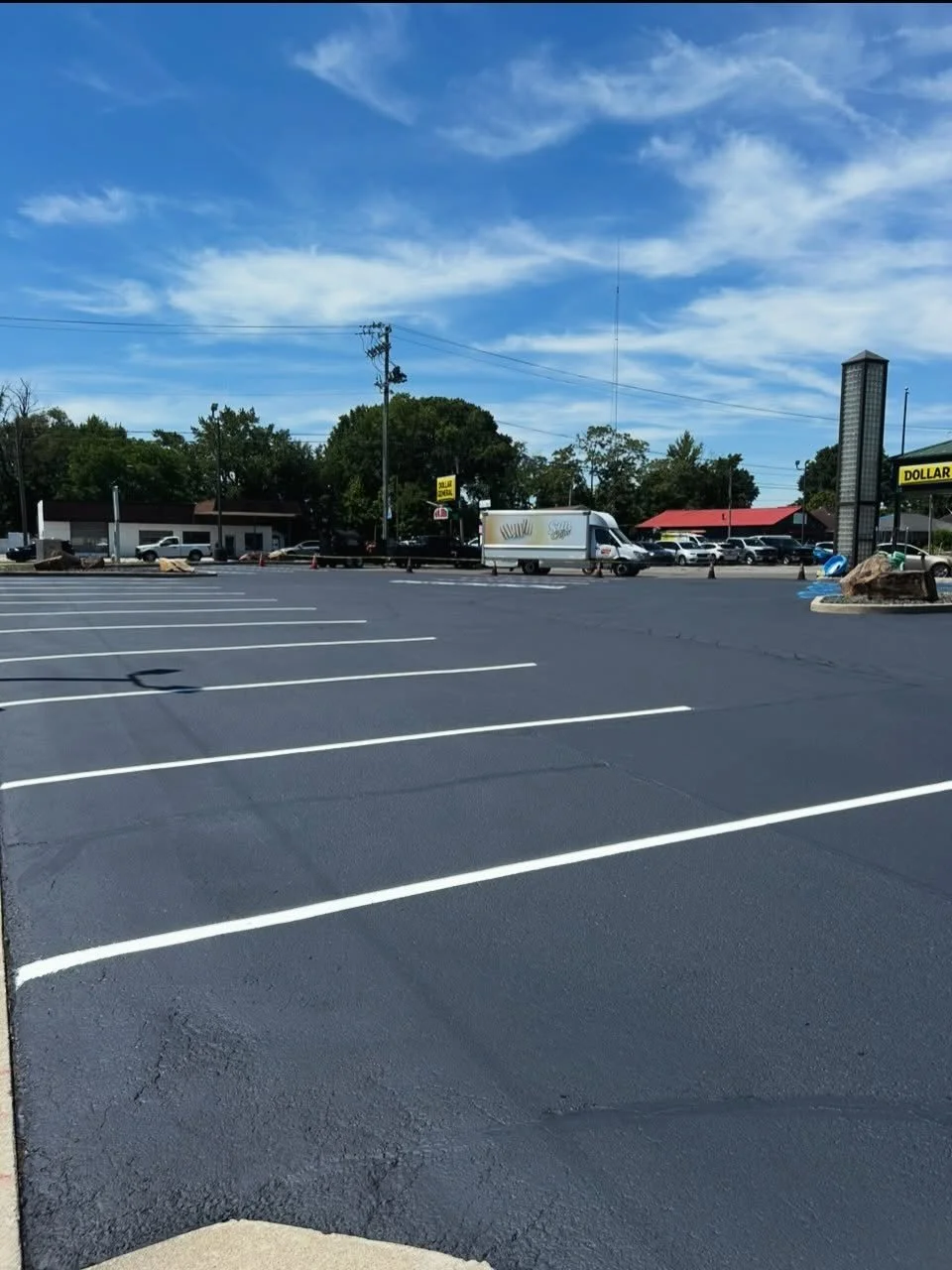 Dollar General in Brownsburg Indiana with sealcoat, crackfilling, and parking lot striping completed by Blacktop Boss. 