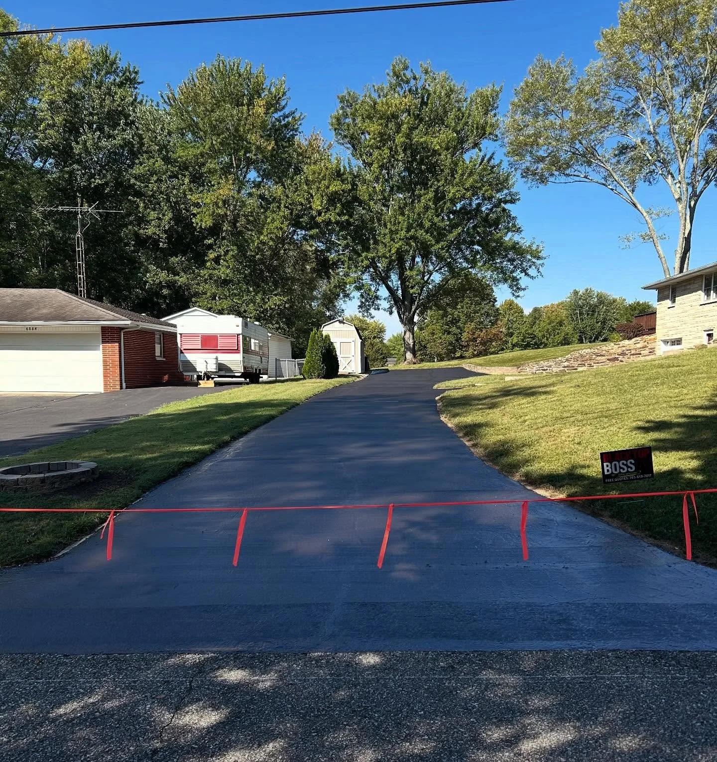 This driveway in Columbus, Indiana received some sealcoat and crackfill by Blacktop Boss. 