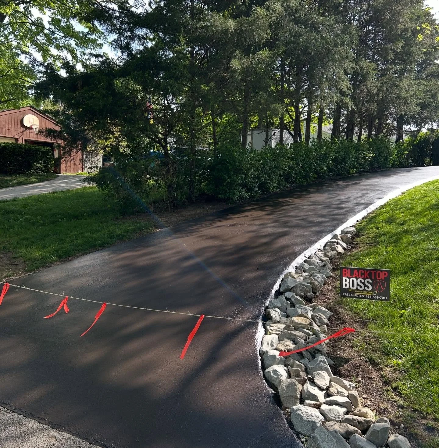 This driveway in Columbus, Indiana got their cracks filled and a fresh sealcoat by Blacktop Boss. 