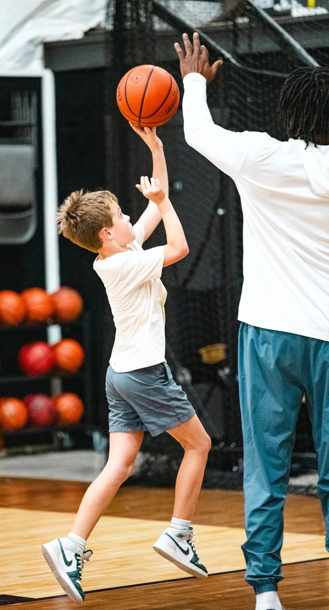 Young athlete practicing basketball shooting with performance coach at Reach Performance in Dripping Springs, Texas.
