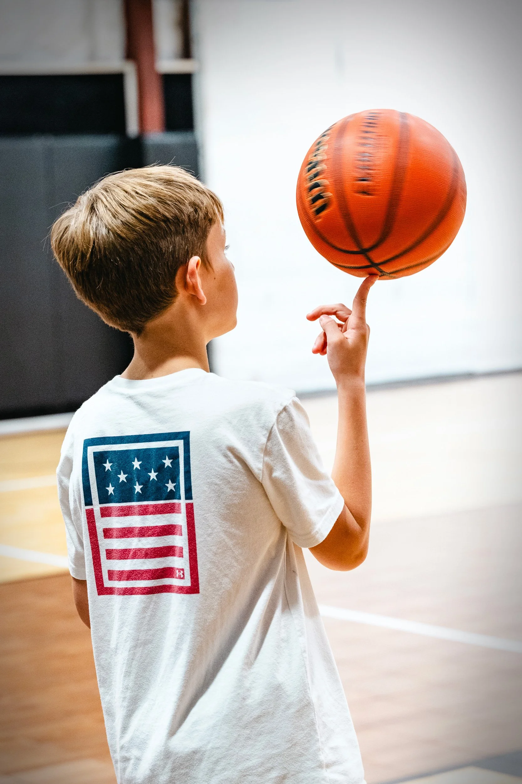 Youth basketball players practicing ball handling on indoor court available for private rental in Dripping Springs.