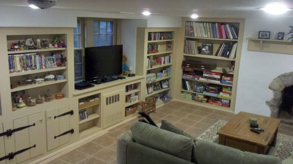 completed finished basement with custom built in shelves
