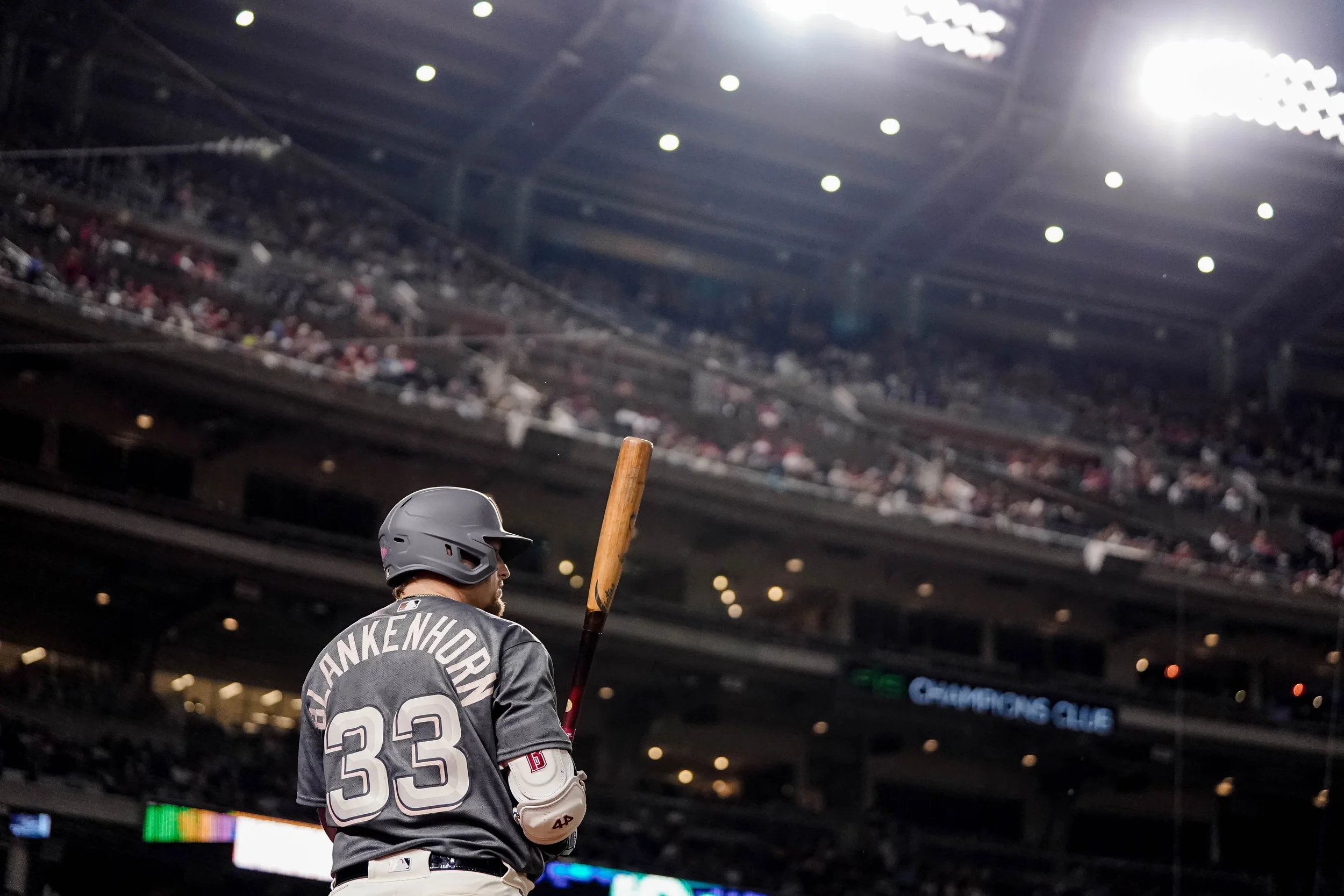 Baseball player with jersey number 33 and name Z. Alenhor and a helmet, holding a bat, inside a stadium with packed audience