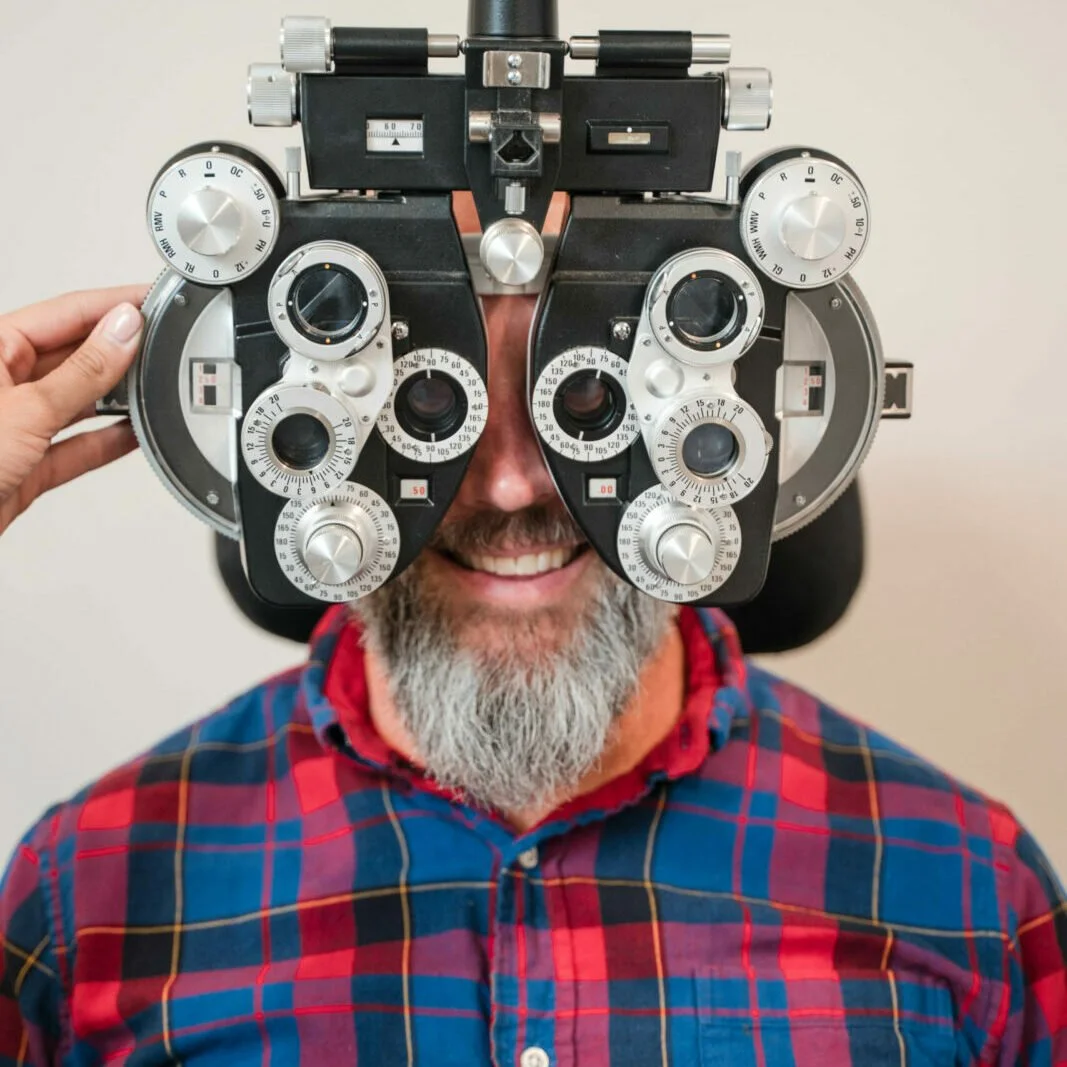 man receiving comprehensive eye exam from optometrist ain Santa Monica