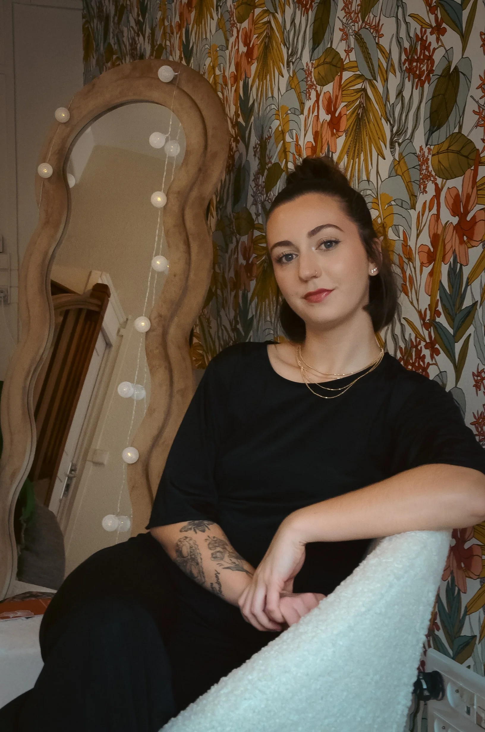 Laurie’s customers, Mariana and Carmen holding hands on a green lawn on their wedding day.