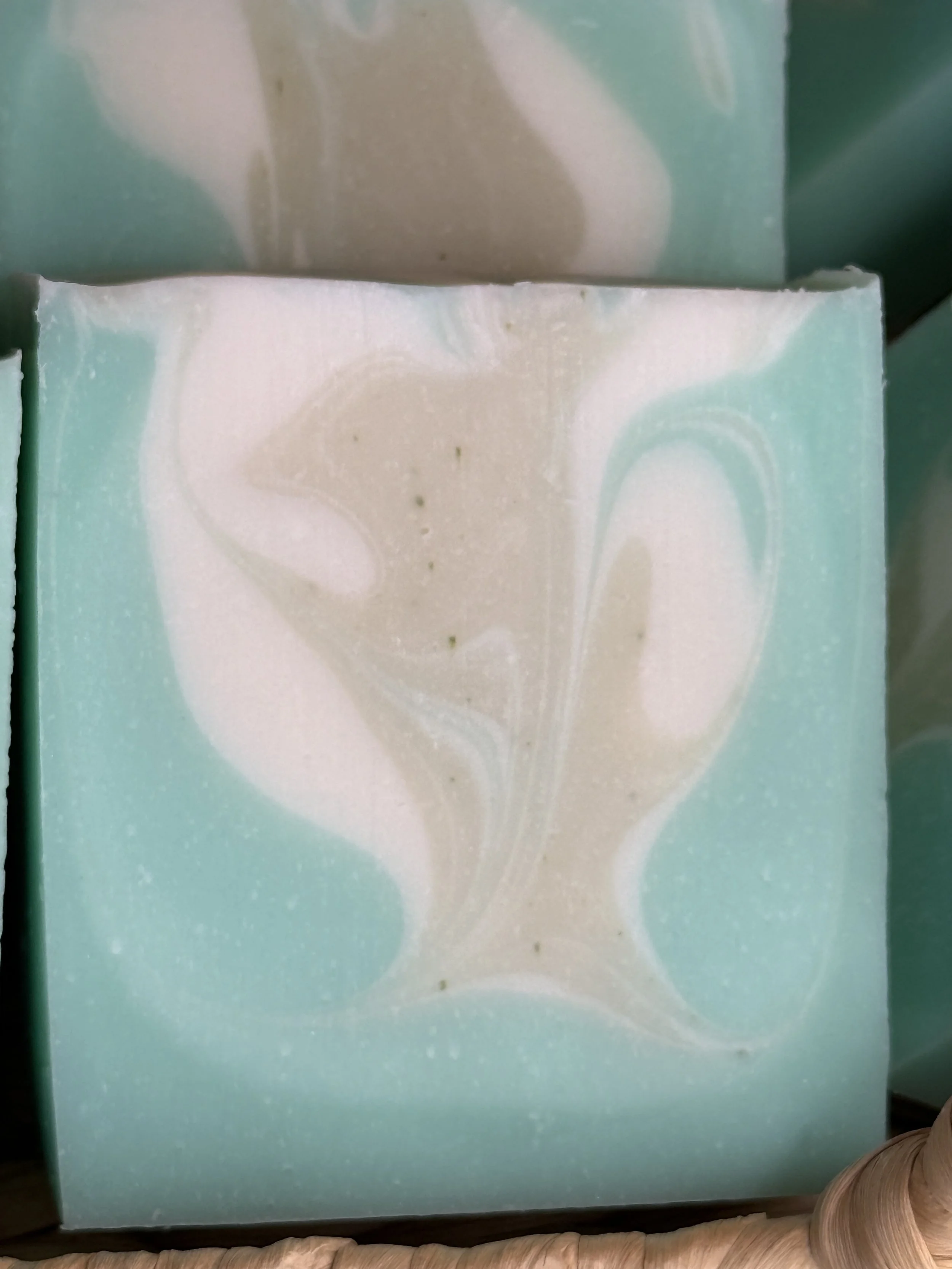 Close-up of handmade beef tallow soap bar with smooth green texture