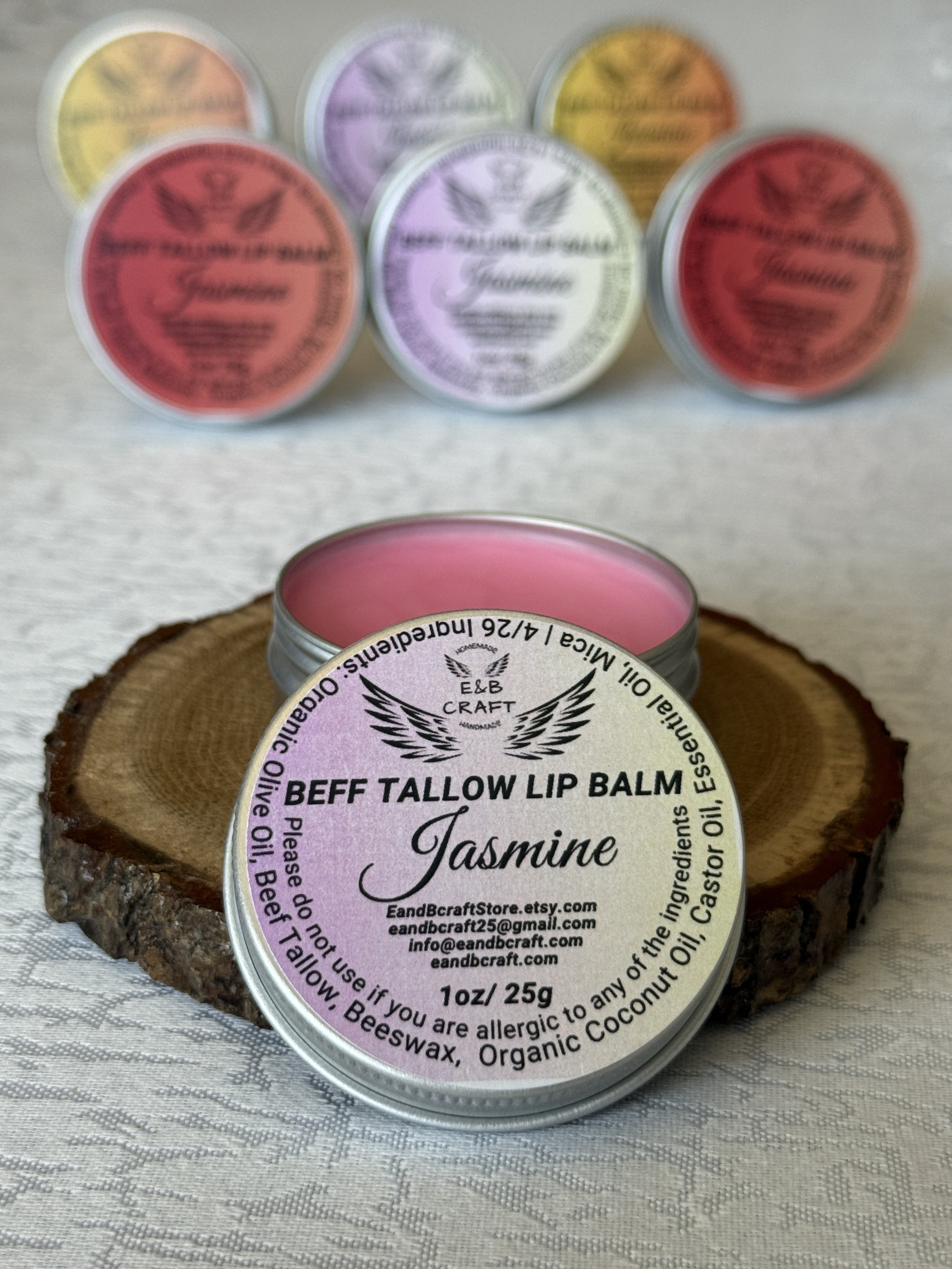 Pink tinted beef tallow lip balm open tin showing creamy texture natural shine