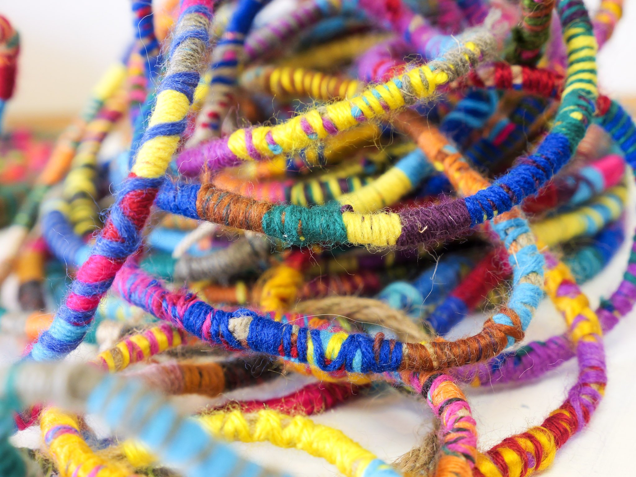 Colorful, multicolored yarn or string tangled together.