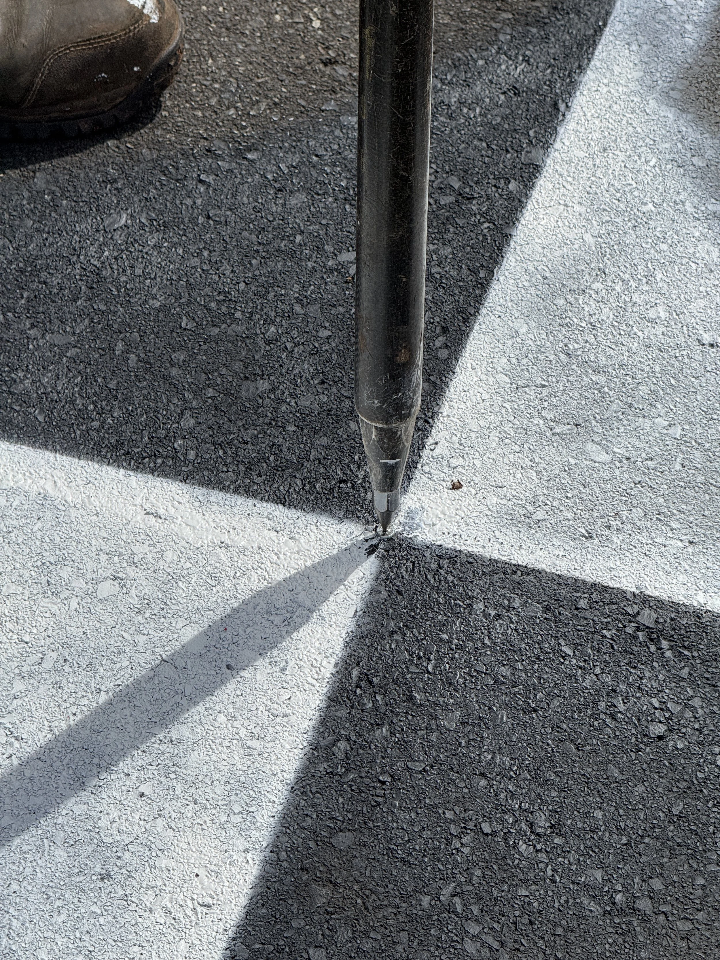 Close up of a painted GCP, Ground Control Point being shot with GPS.