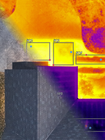 An overlayd Infrared thermal and visible light image showing roof shingles and a driveway.