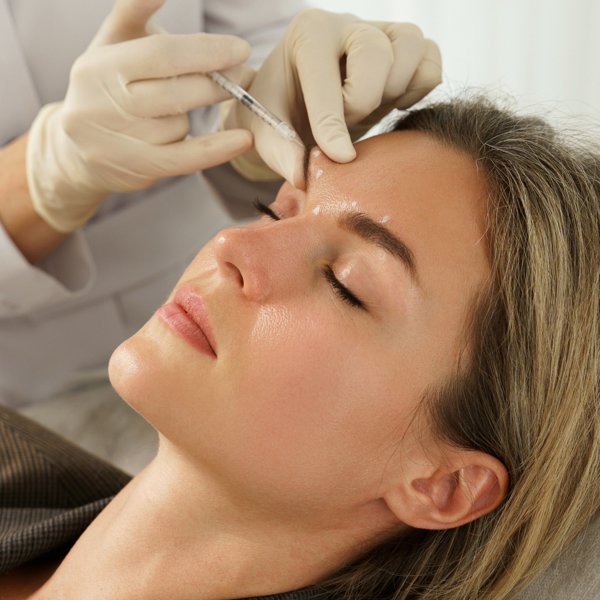 Image of a white woman being given botox by a consultant dermatologist in Leeds