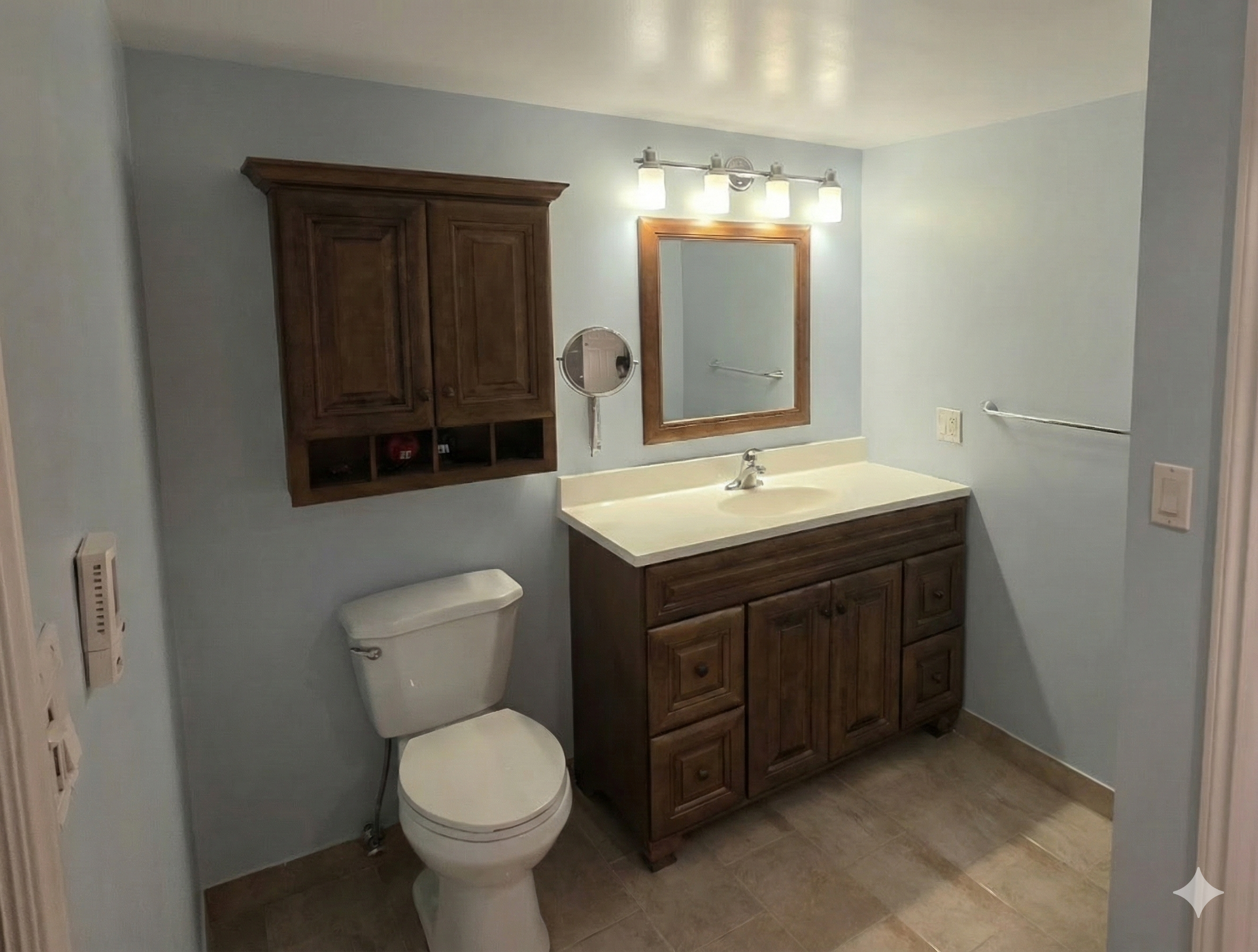 Interior painting in Cambridge — bathroom with dark wood vanity and light grey walls painted by Major Painting