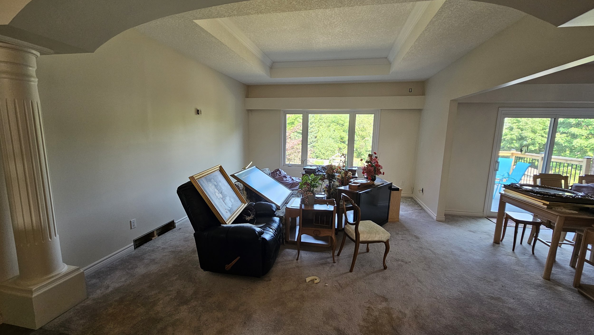 Interior painting in Cambridge — living and dining room with tray ceiling and neutral walls by Major Painting