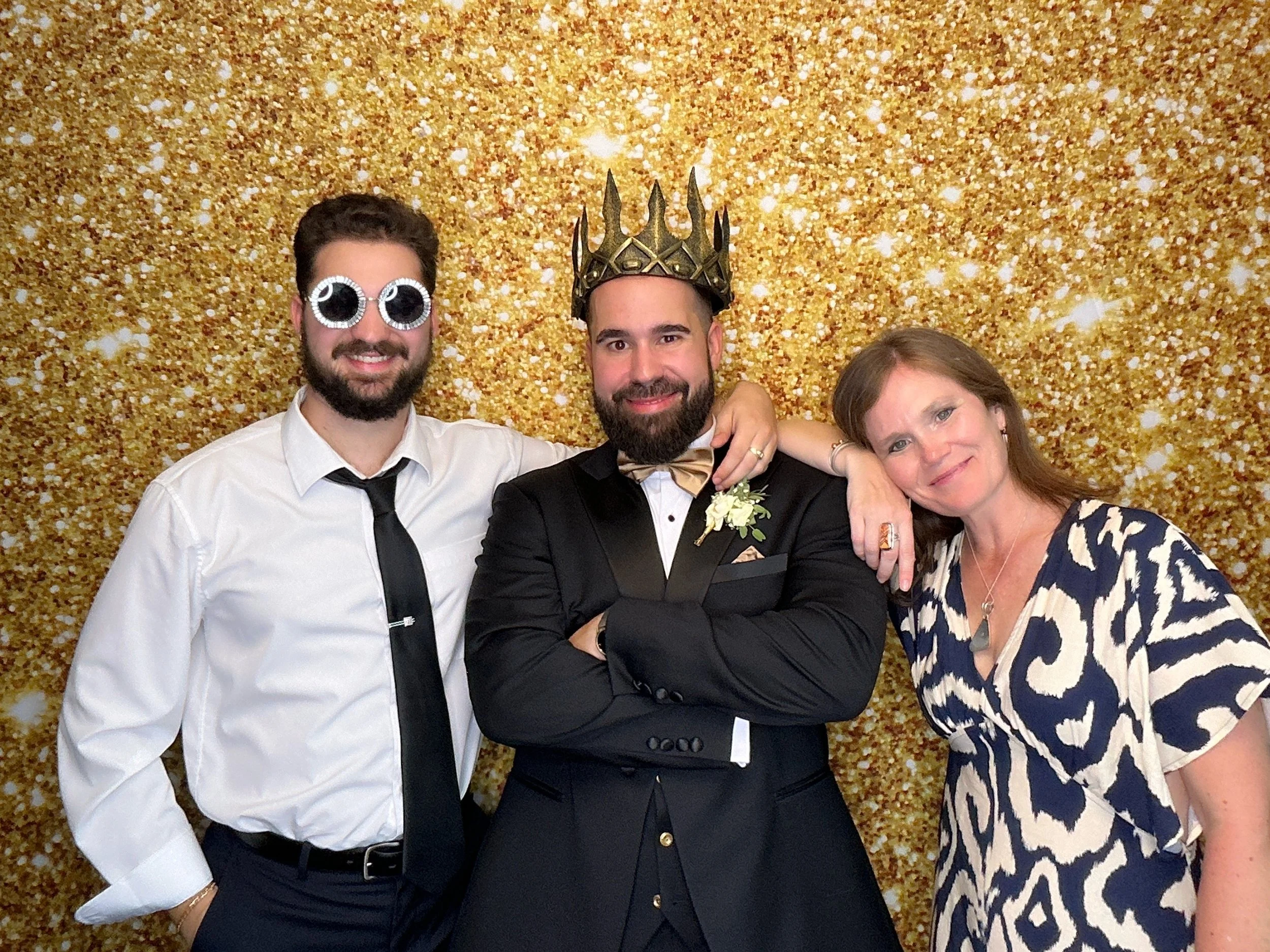 Groom posing with guests at an Orlando wedding Photo Booth rental by Pop & Pose Events.