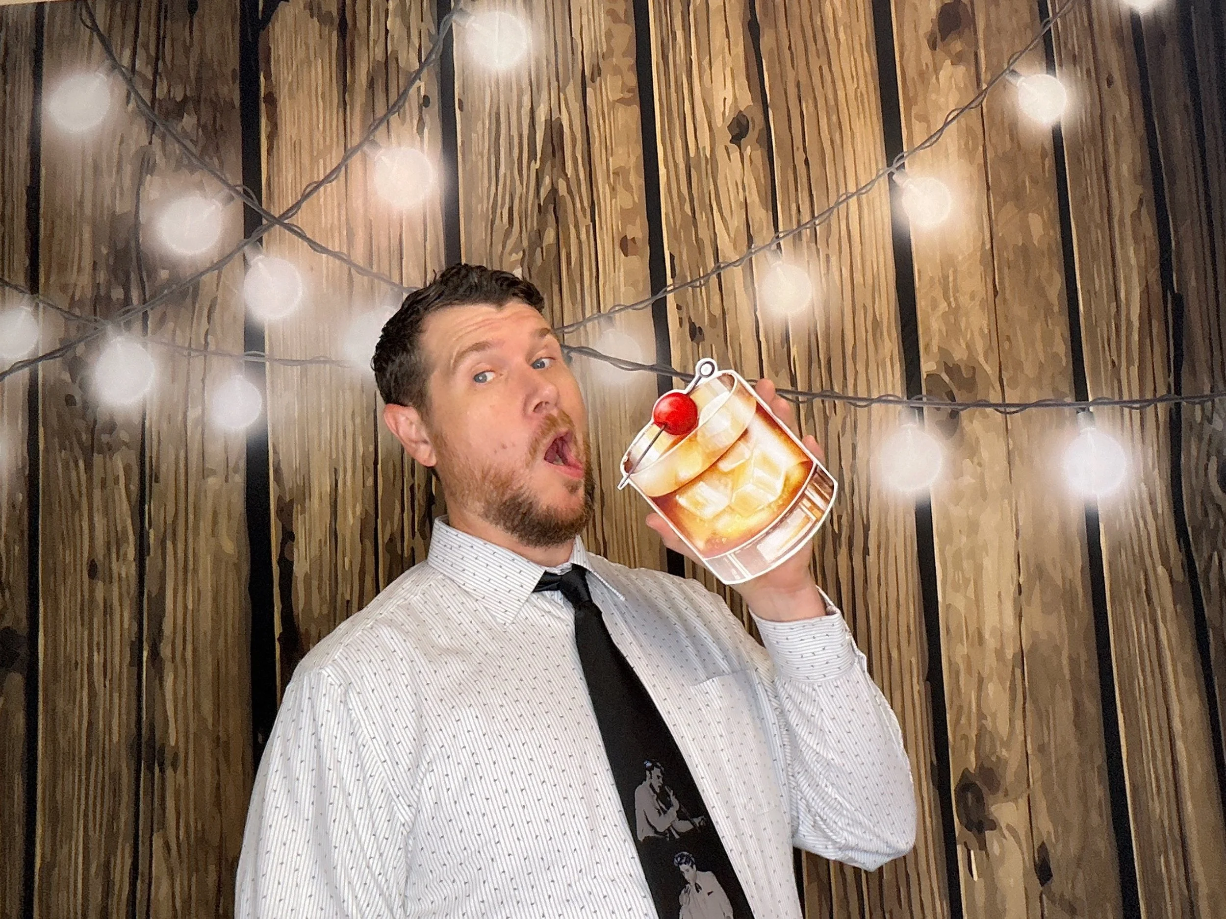 Guest enjoying the Pop & Pose Events Photo Booth at a themed birthday celebration with fun props and a custom backdrop.