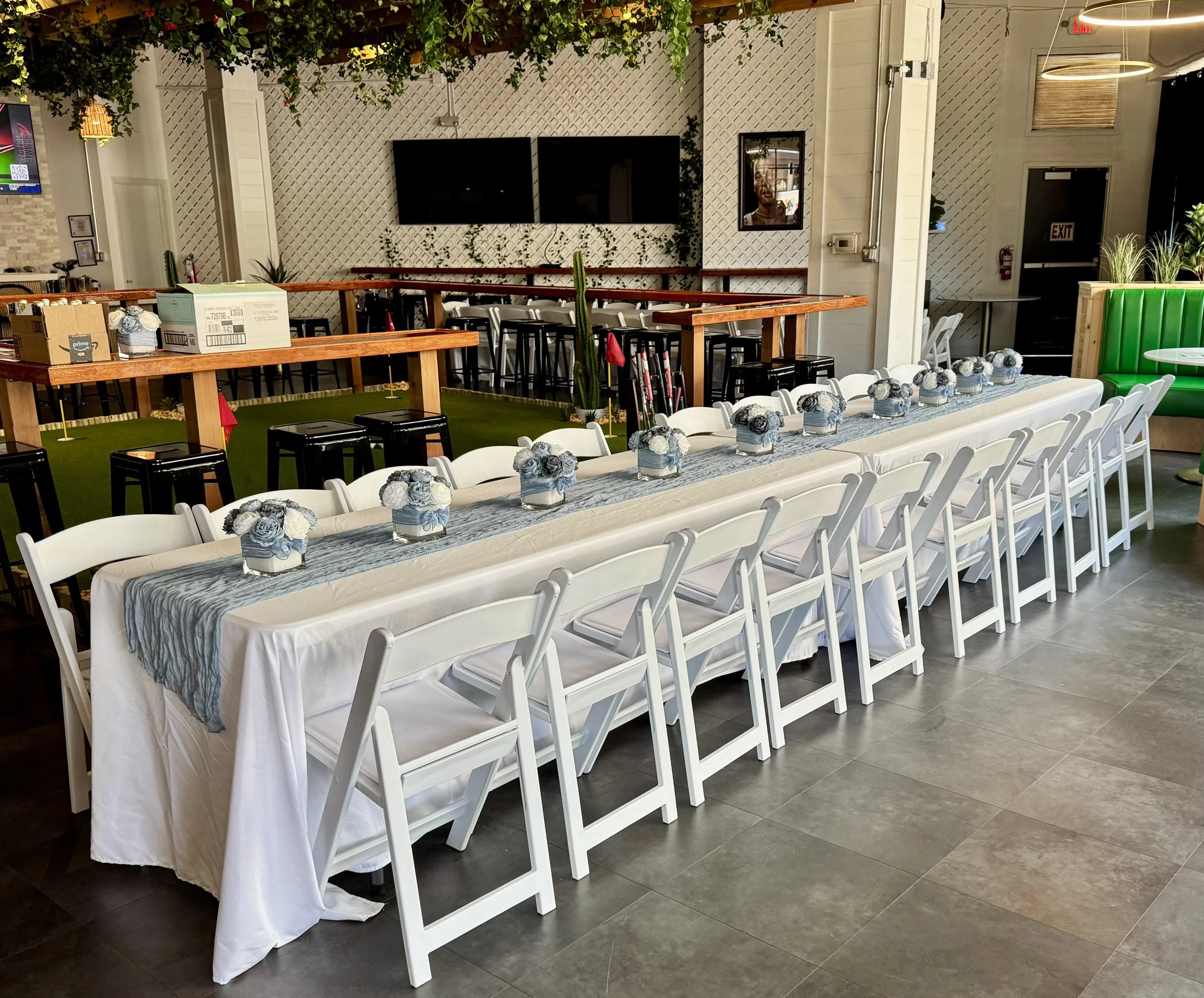 Elegant table and chair rental setup with white resin chairs and banquet tables for a special event in Orlando, Florida.