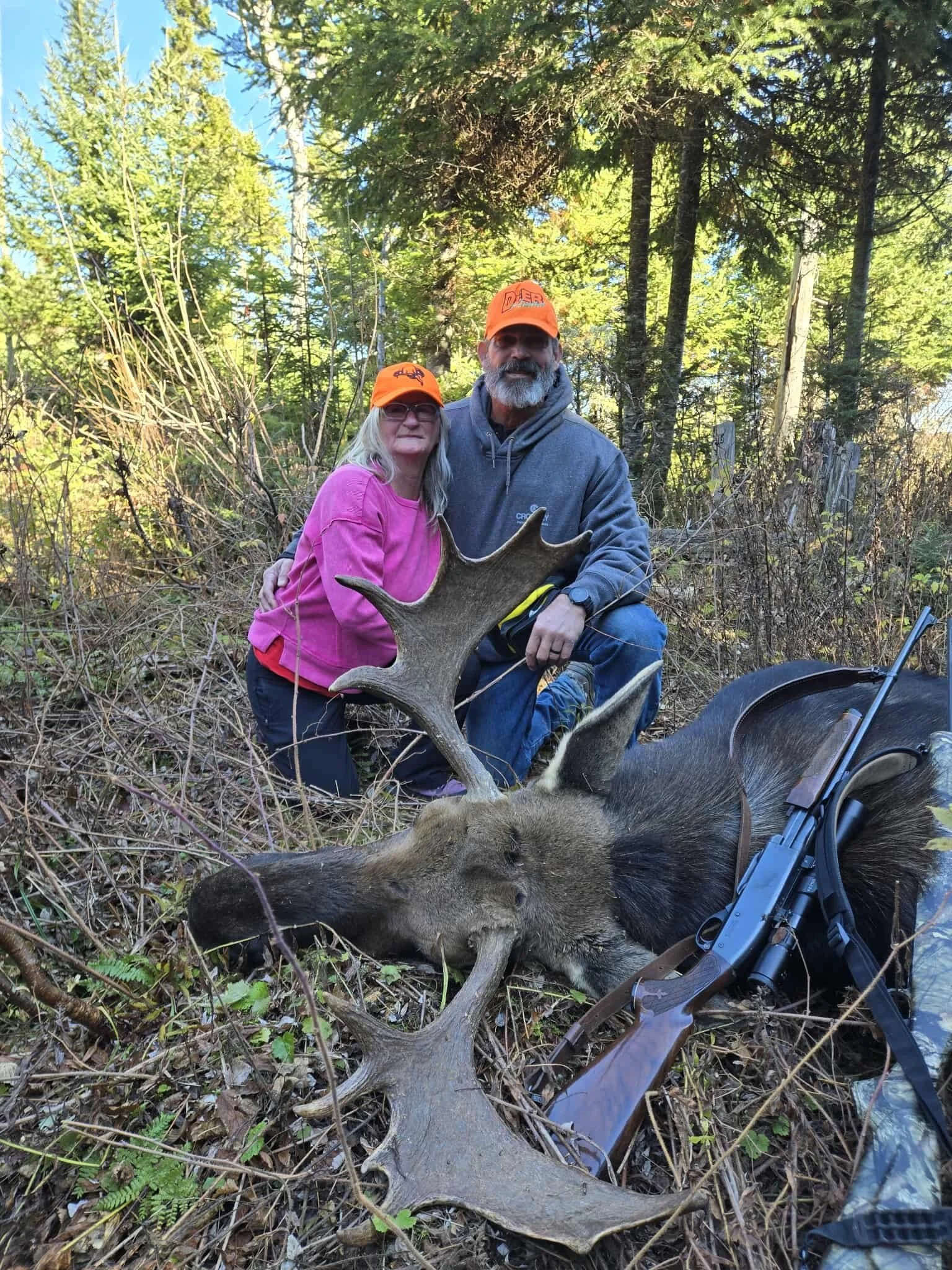A couple posing with their bull moose harvested in a successful Moose hunt.