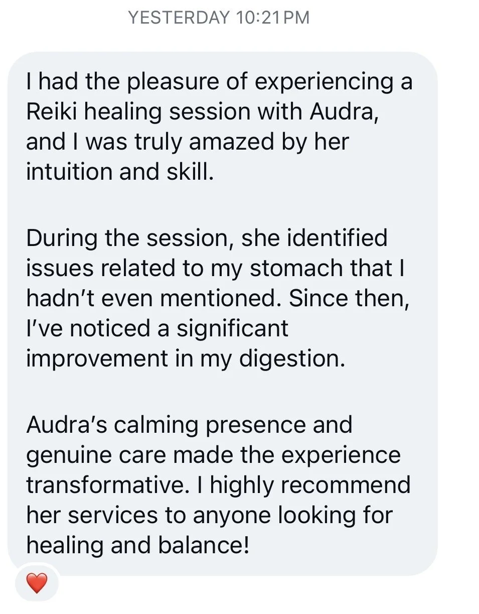 Text message from someone sharing their positive experience with a Reiki healing session with Audra, highlighting improvements in digestion and overall well-being, with a red heart emoji at the end.