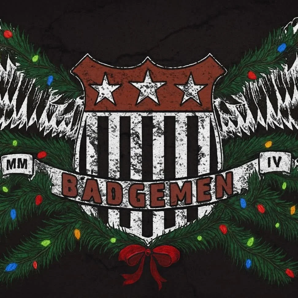 A festive emblem featuring a shield with three stars and black and white stripes, surrounded by green Christmas garland with colorful lights, with the word Badgemen in red, the Roman numerals MM and IV, and a red bow at the bottom.