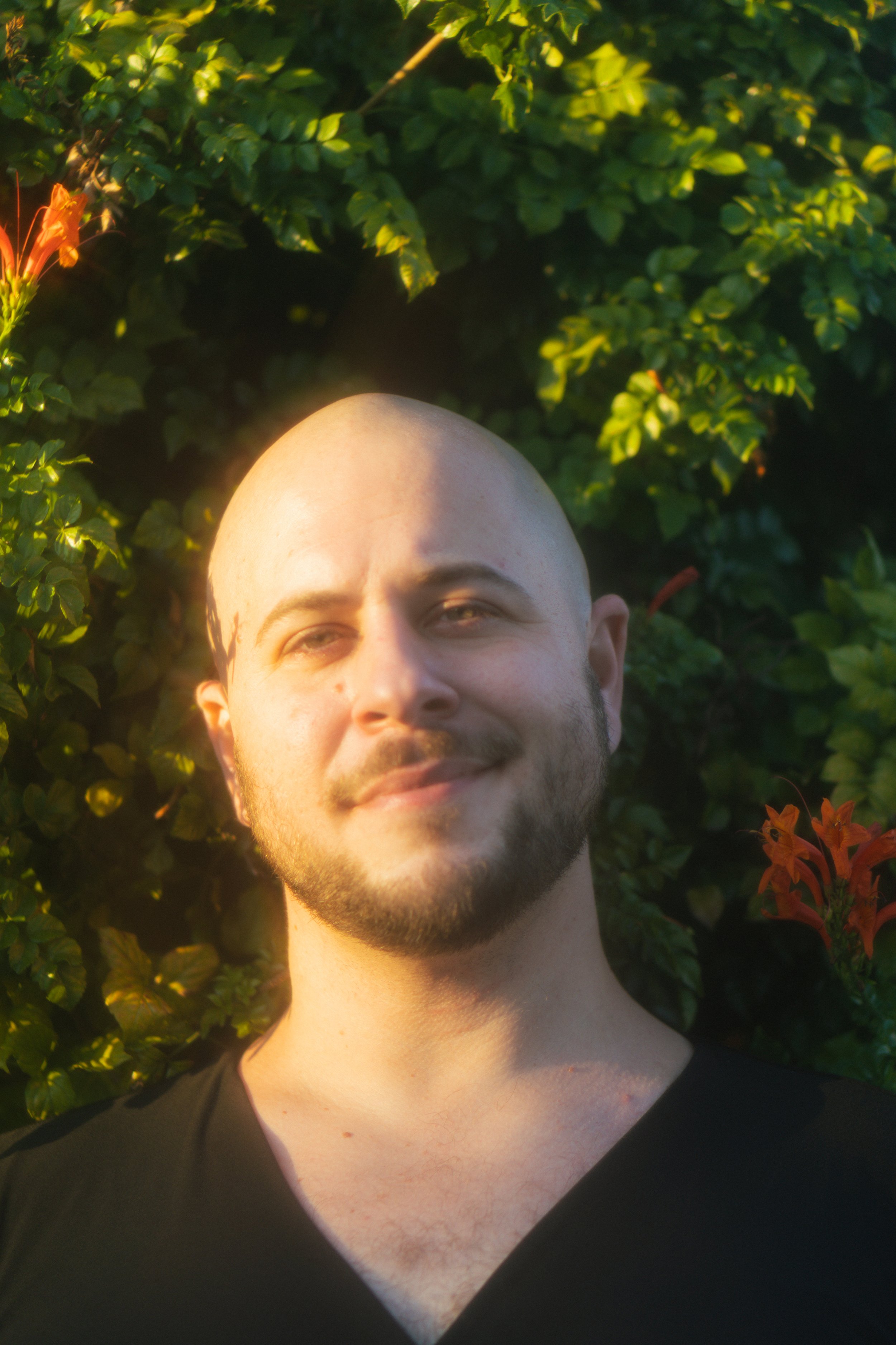 Bald person with beard looking at cam