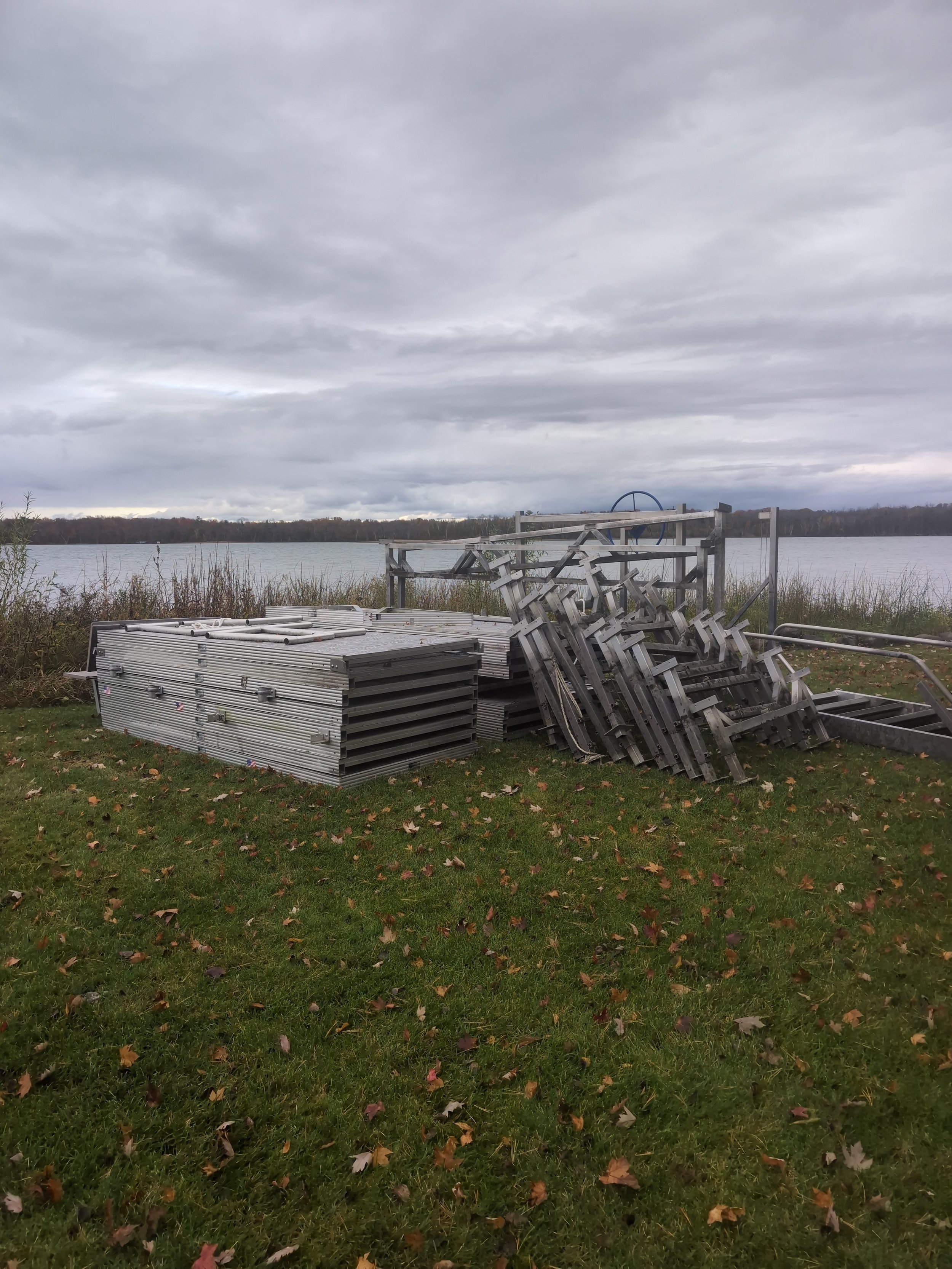 Aluminum dock sections stacked with legs in Grawn