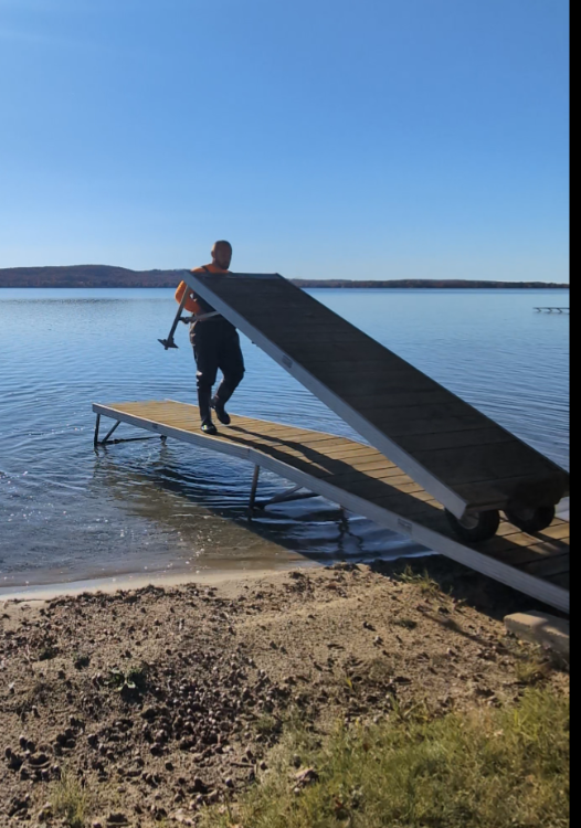 wooden dock being removed from water inland lake