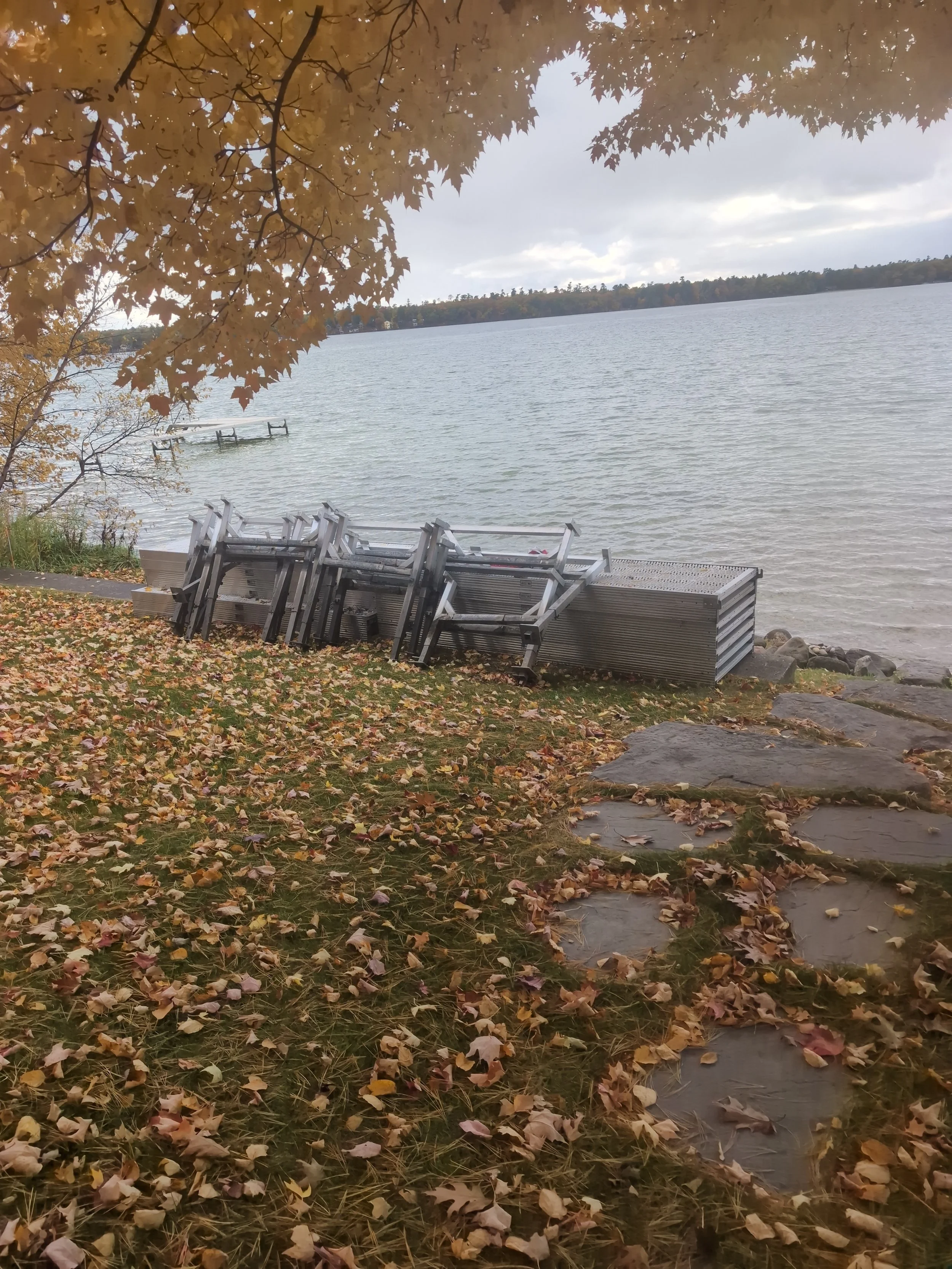 Twin Bay dock sections stacked near duck lake in Grawn michigan ready for winter