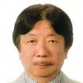 A portrait of an Asian man with black hair, wearing a grey suit and a light-colored shirt, against a white background.